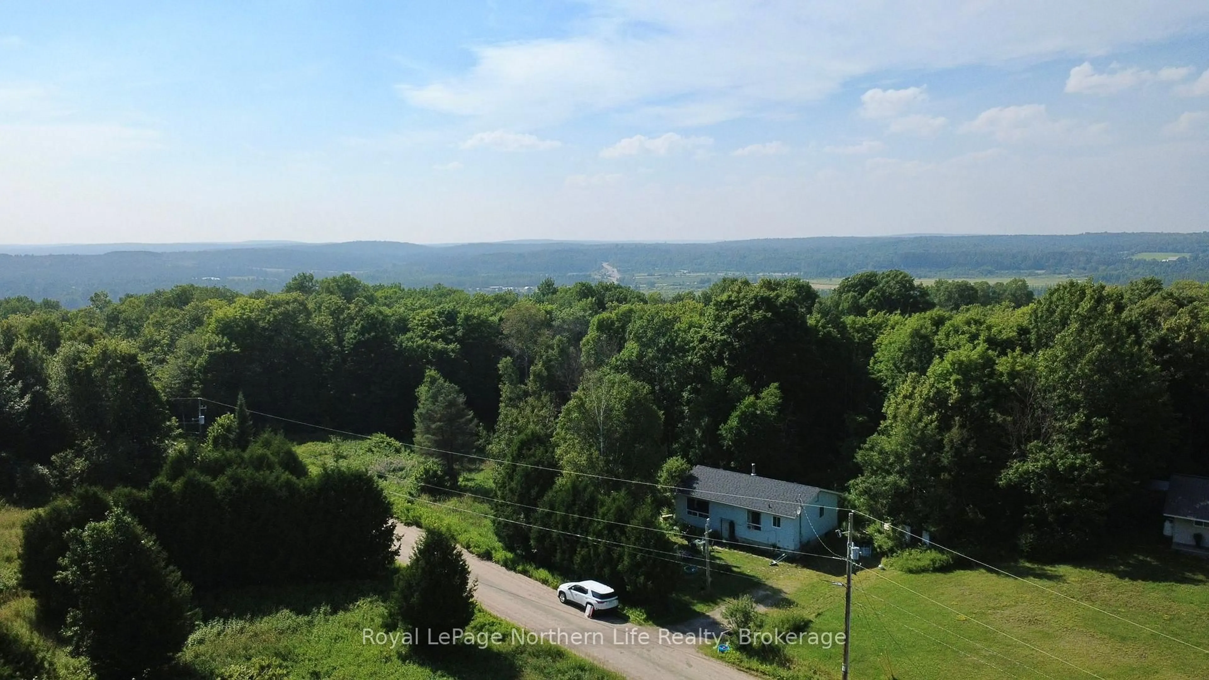 A pic from outside/outdoor area/front of a property/back of a property/a pic from drone, water/lake/river/ocean view for 494 Main St, Powassan Ontario P0H 2L0