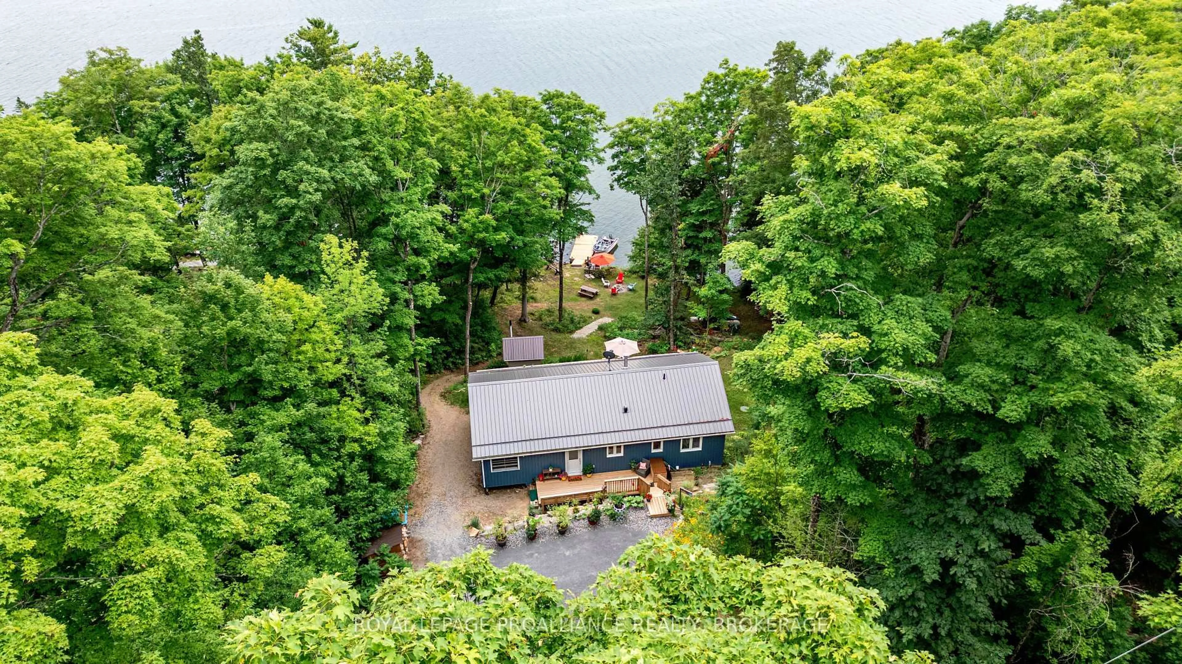 A pic from outside/outdoor area/front of a property/back of a property/a pic from drone, water/lake/river/ocean view for 1099 Almost Lane, Ardoch Ontario K0H 1C0