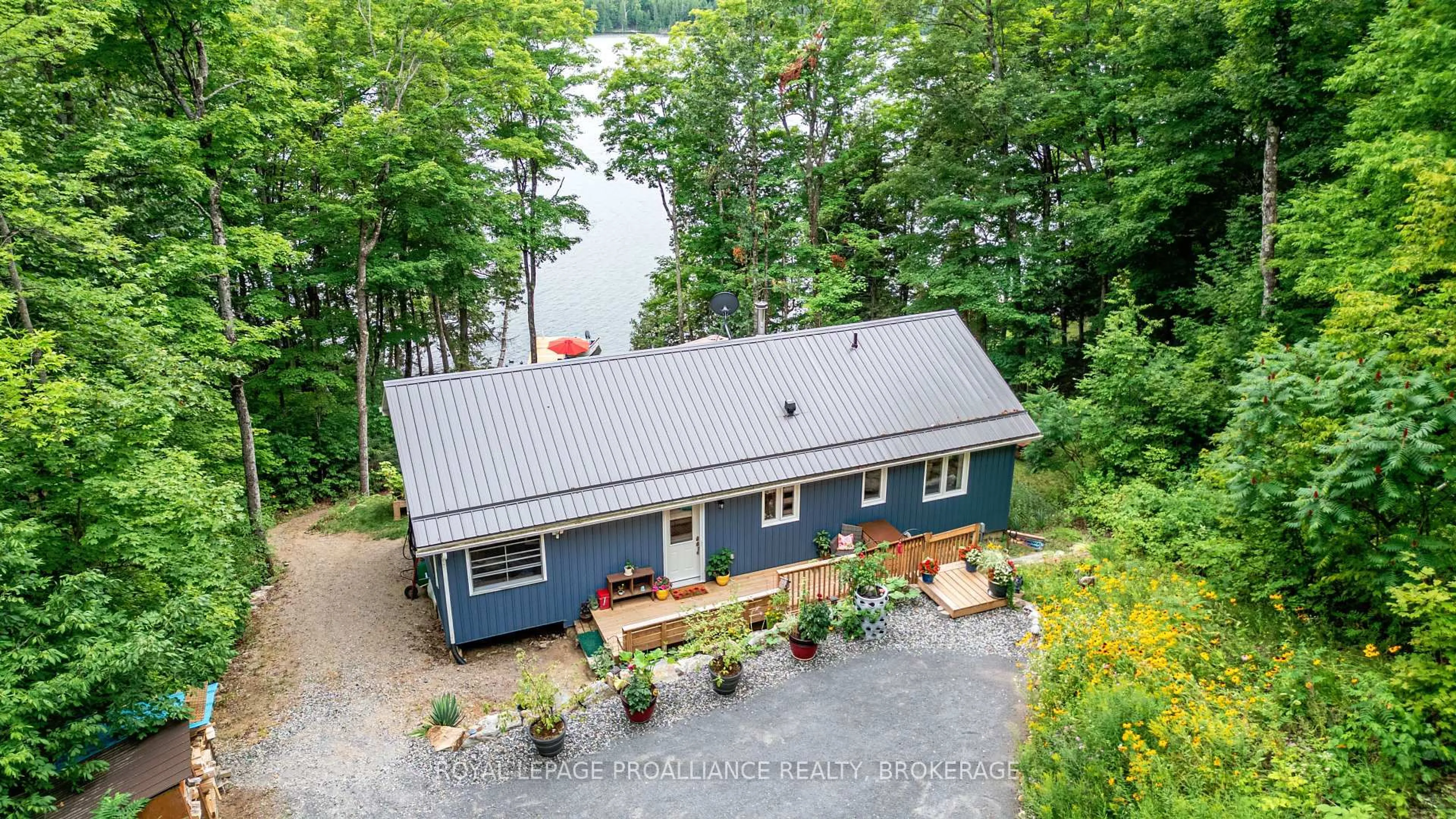A pic from outside/outdoor area/front of a property/back of a property/a pic from drone, water/lake/river/ocean view for 1099 Almost Lane, Ardoch Ontario K0H 1C0