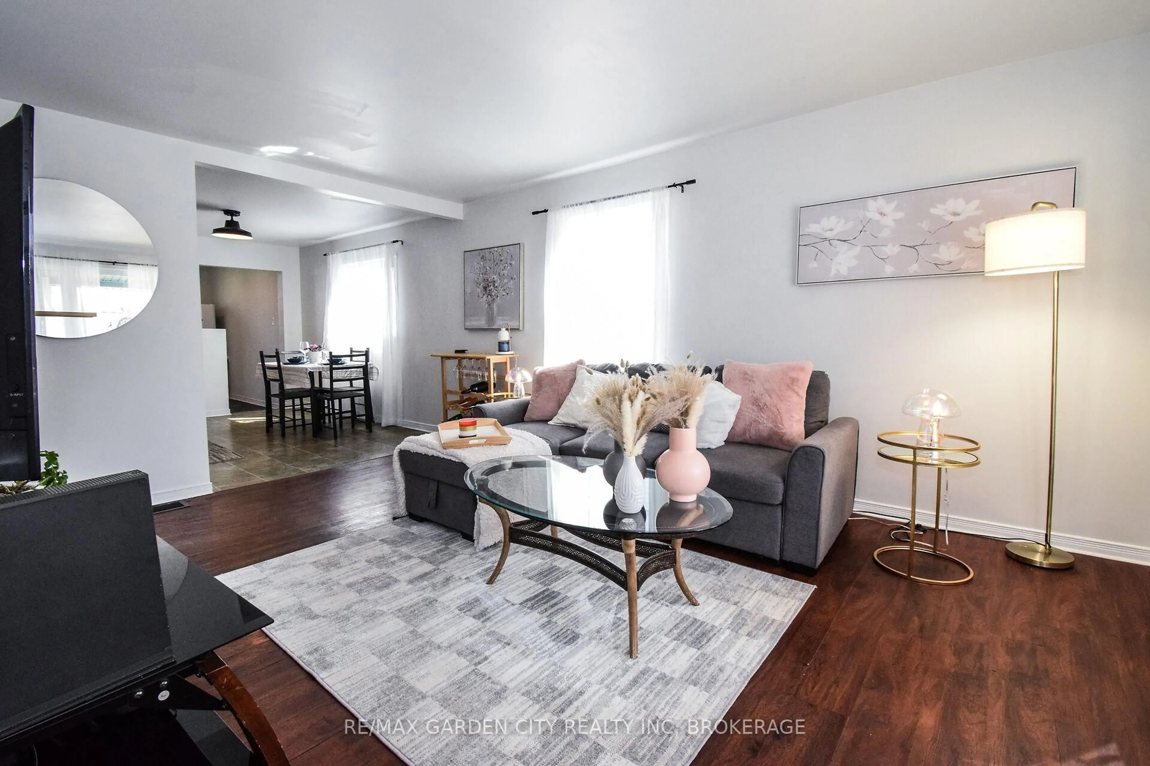 Living room with furniture, wood/laminate floor for 20 Ajax Ave, Welland Ontario L3B 4W8