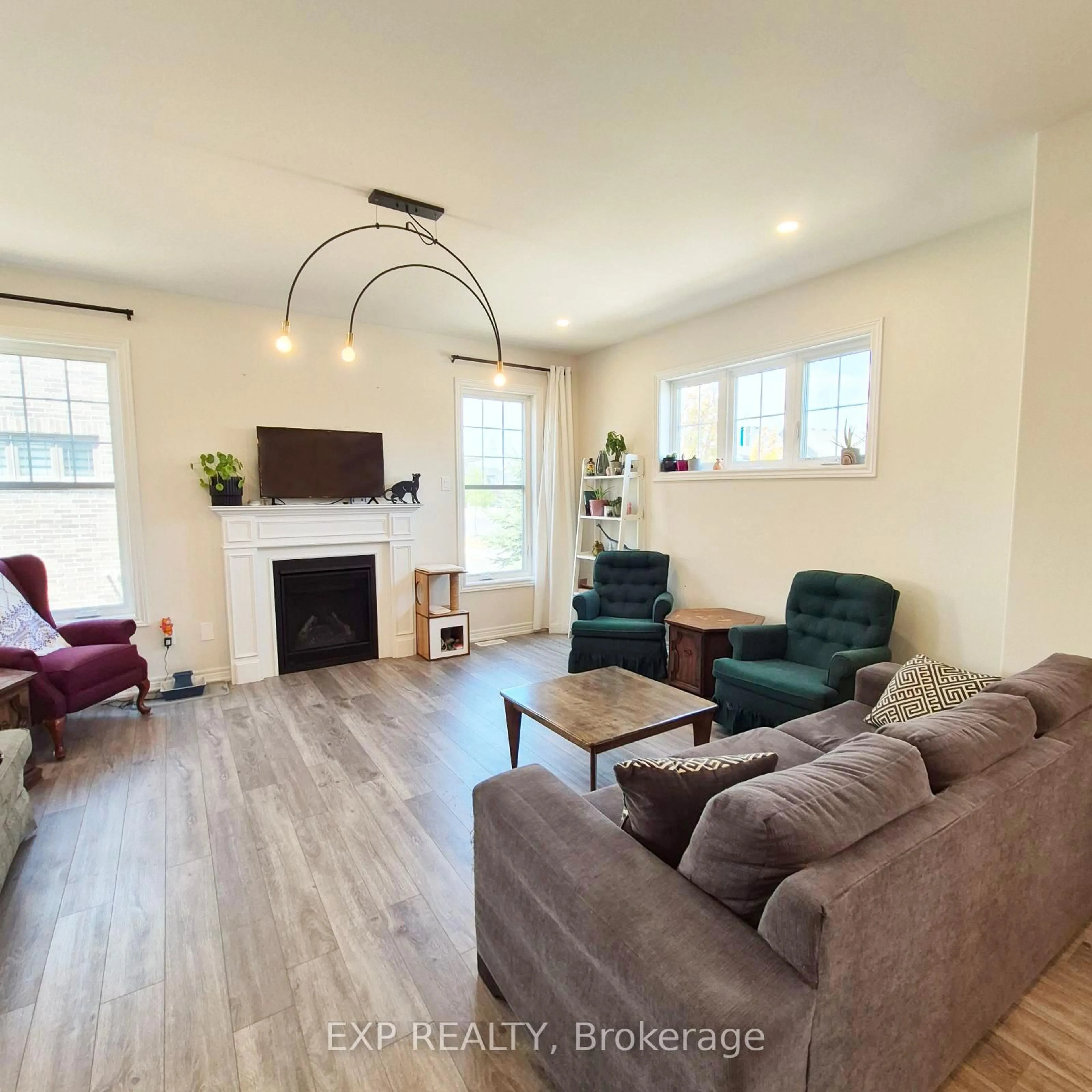 Living room with furniture, wood/laminate floor for 1056 Rippingale Tr, Peterborough North Ontario K9H 0J8