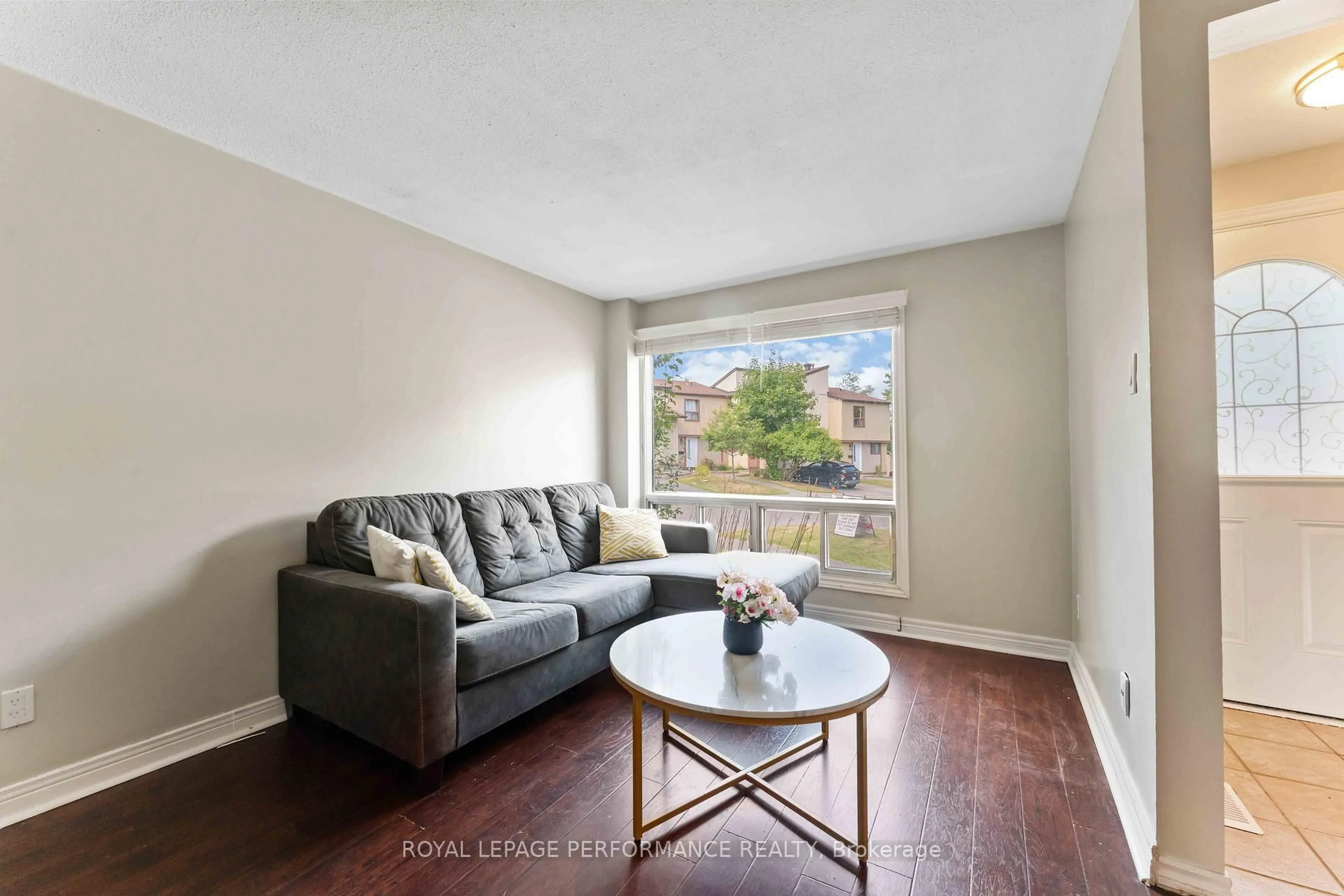 Living room with furniture, wood/laminate floor for 1439 Bethamy Lane #28, Ottawa Ontario K1J 8P7