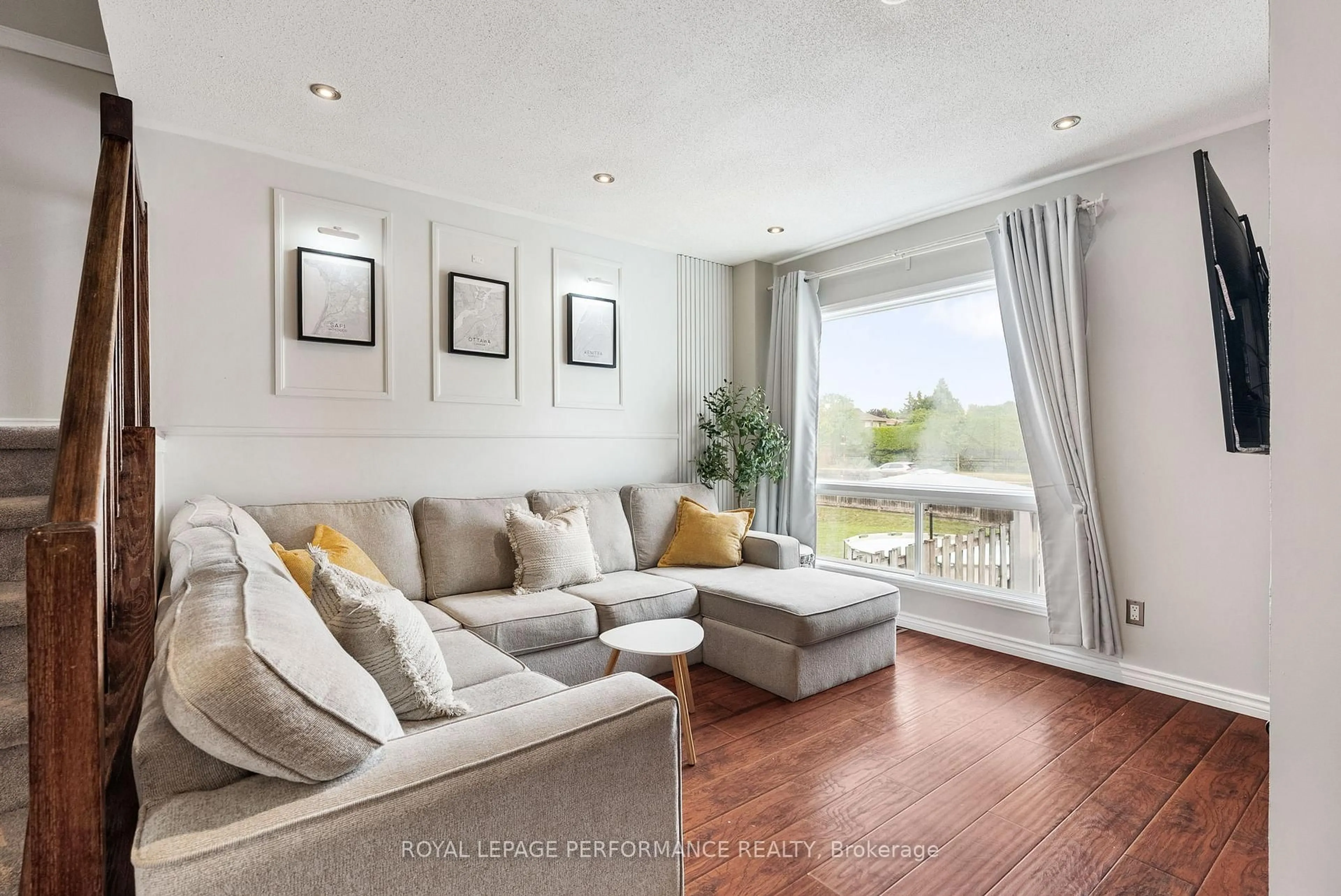 Living room with furniture, wood/laminate floor for 1631 Greywood Dr, Ottawa Ontario K1C 7L9