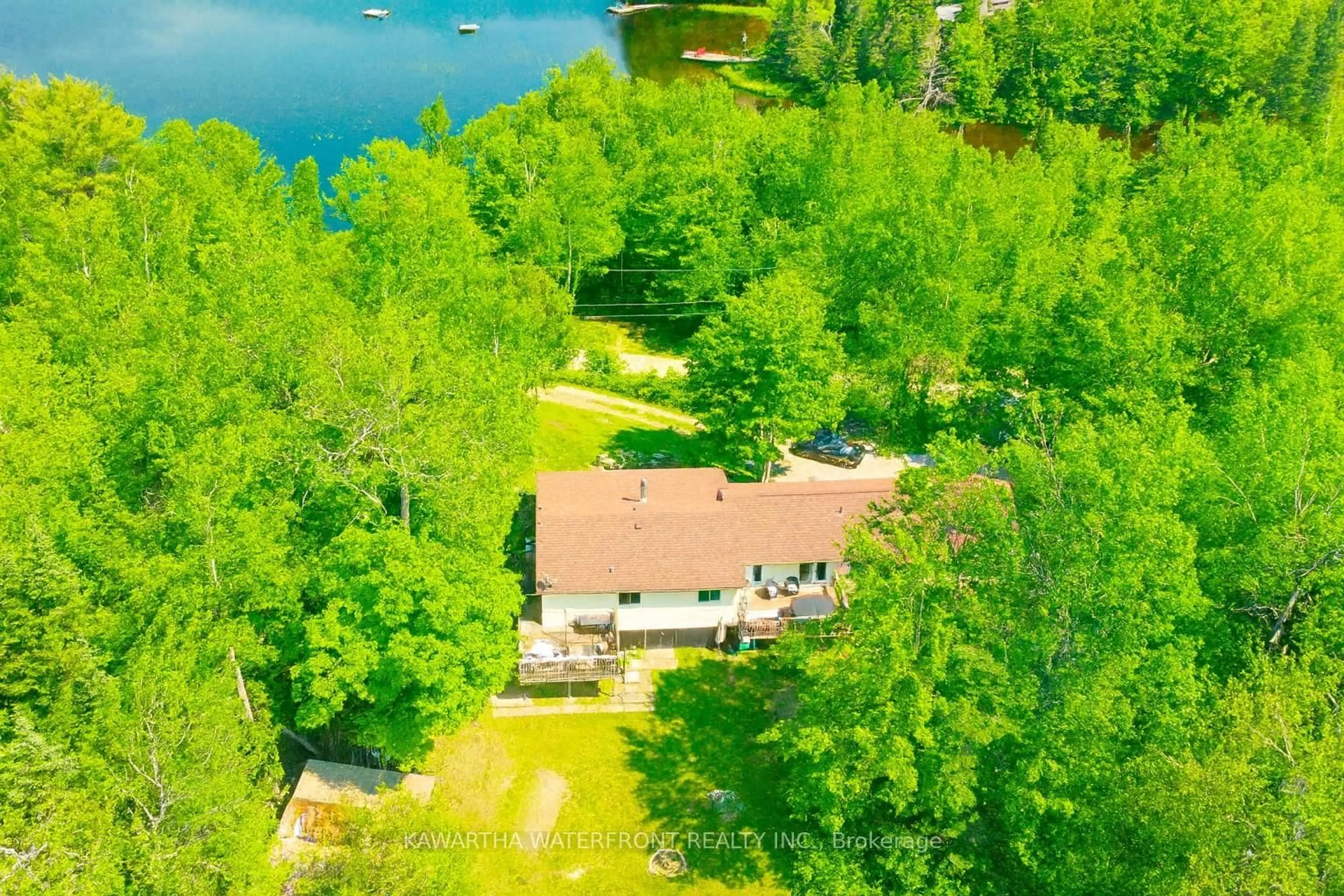 A pic from outside/outdoor area/front of a property/back of a property/a pic from drone, water/lake/river/ocean view for 1170 English Circ, Highlands East Ontario K0M 1R0