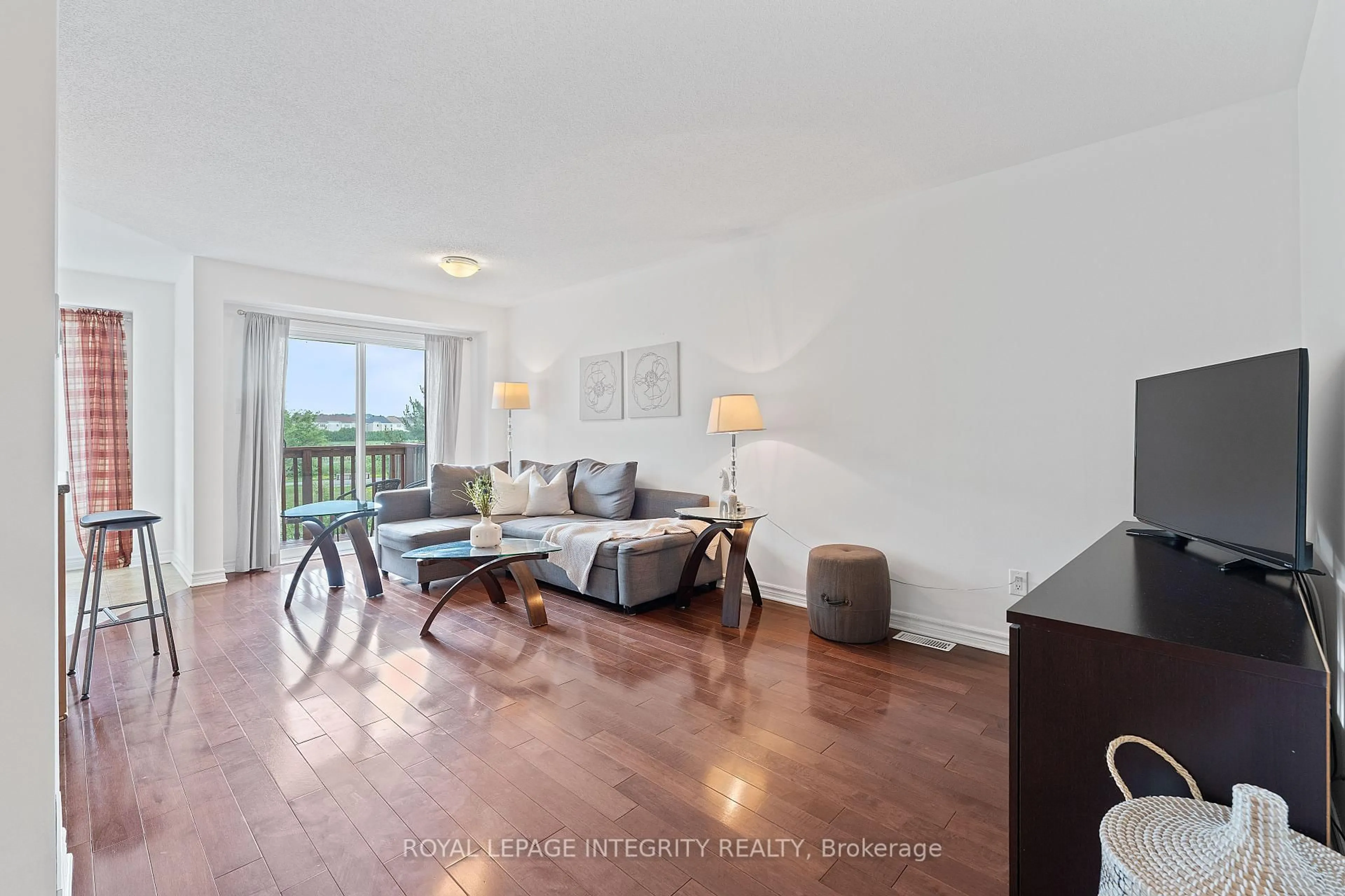 Living room with furniture, wood/laminate floor for 258 Catamount Crt, Ottawa Ontario K2M 0A9