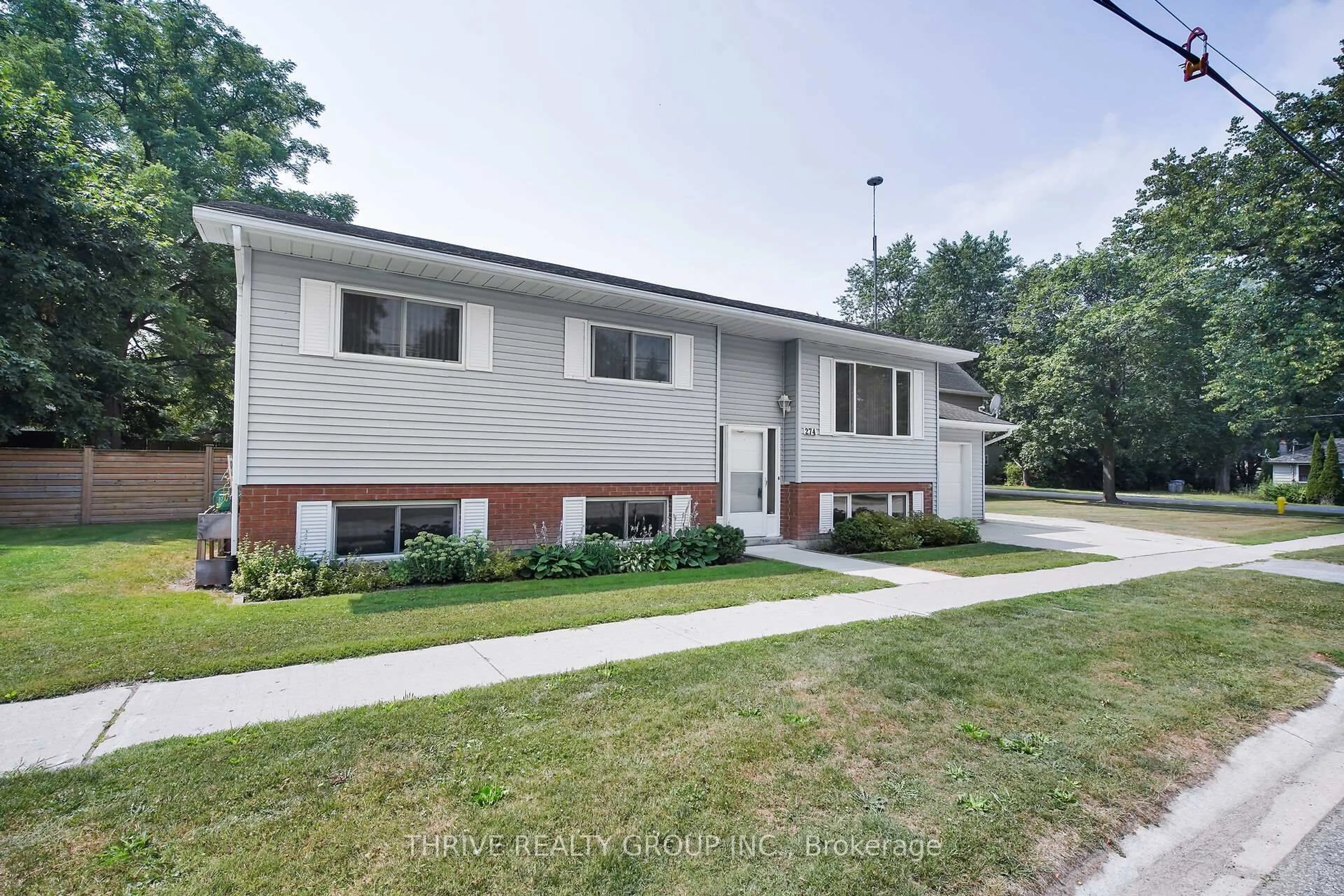 Home with vinyl exterior material, street for 274 Station St, North Middlesex Ontario N0M 2K0