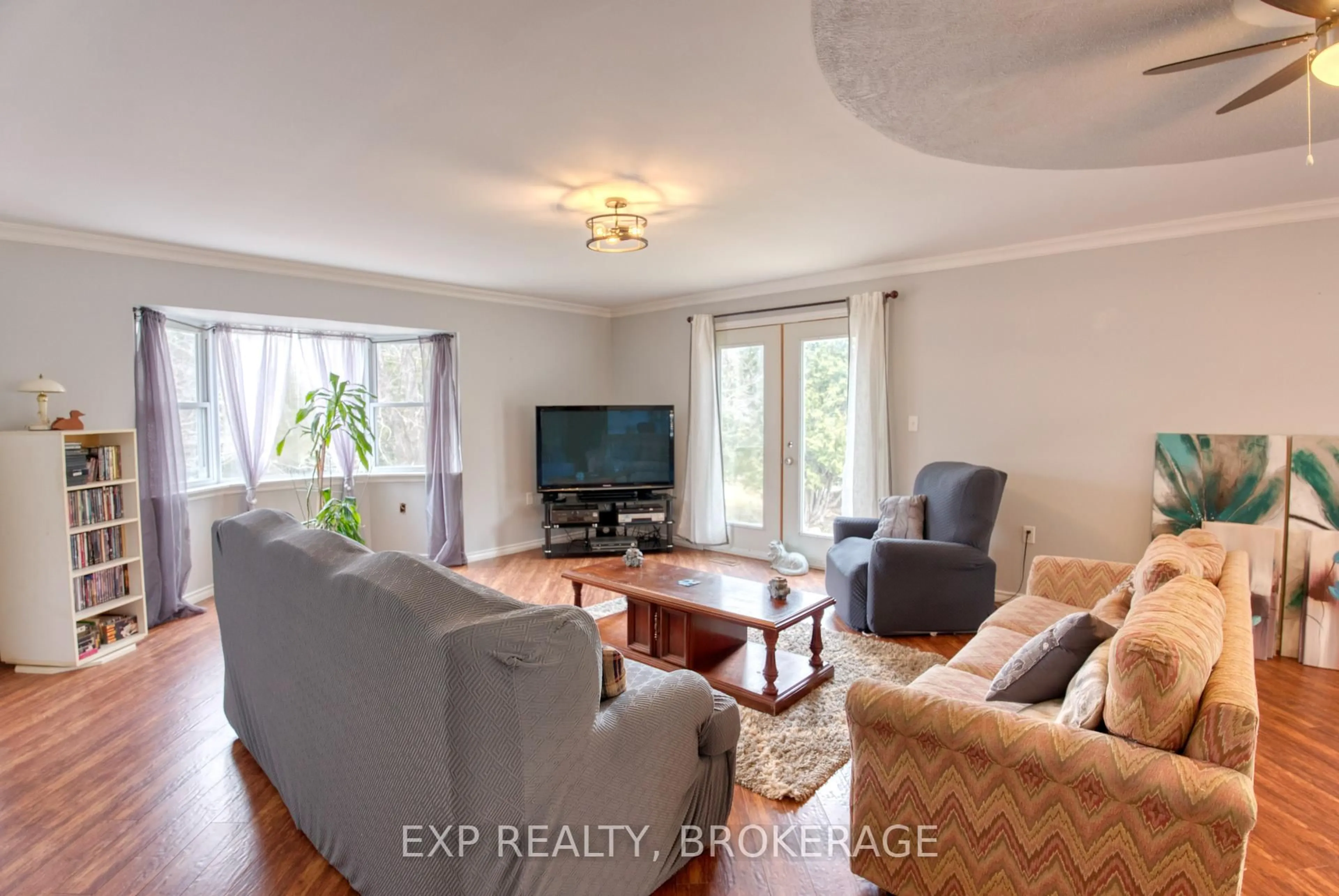 Living room with furniture, wood/laminate floor for 1073 Cox Rd, Arden Ontario K0H 1B0