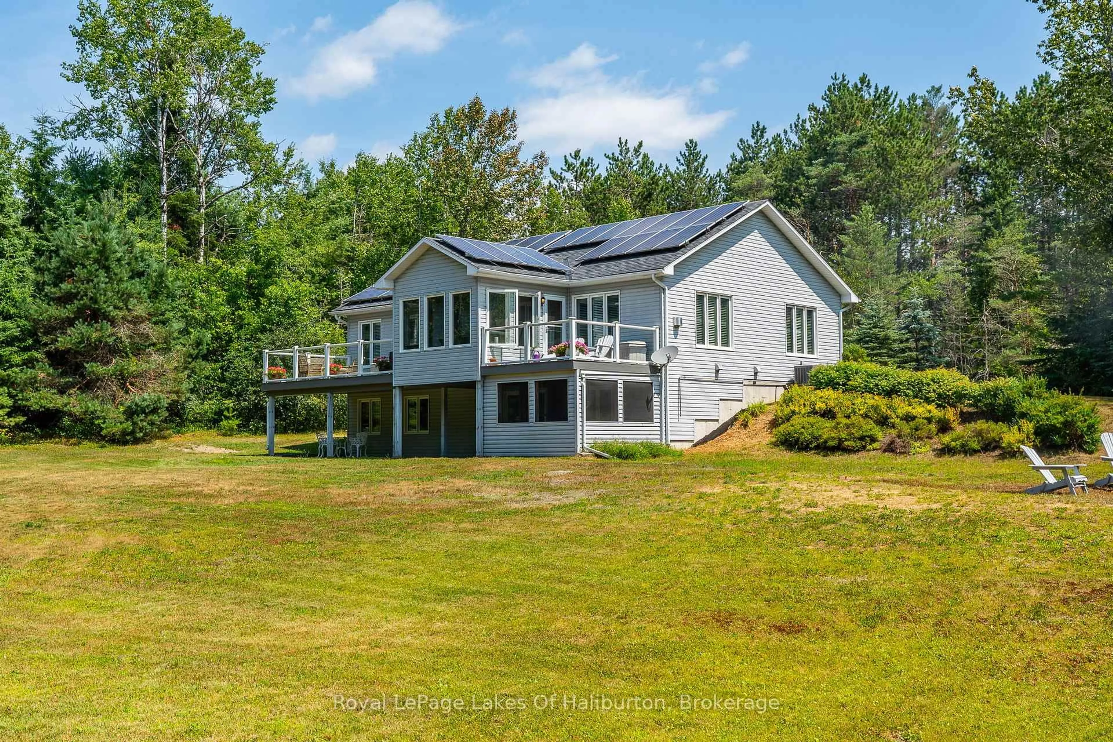 A pic from outside/outdoor area/front of a property/back of a property/a pic from drone, water/lake/river/ocean view for 1030 Sawdust Rd, Minden Hills Ontario K0M 2K0