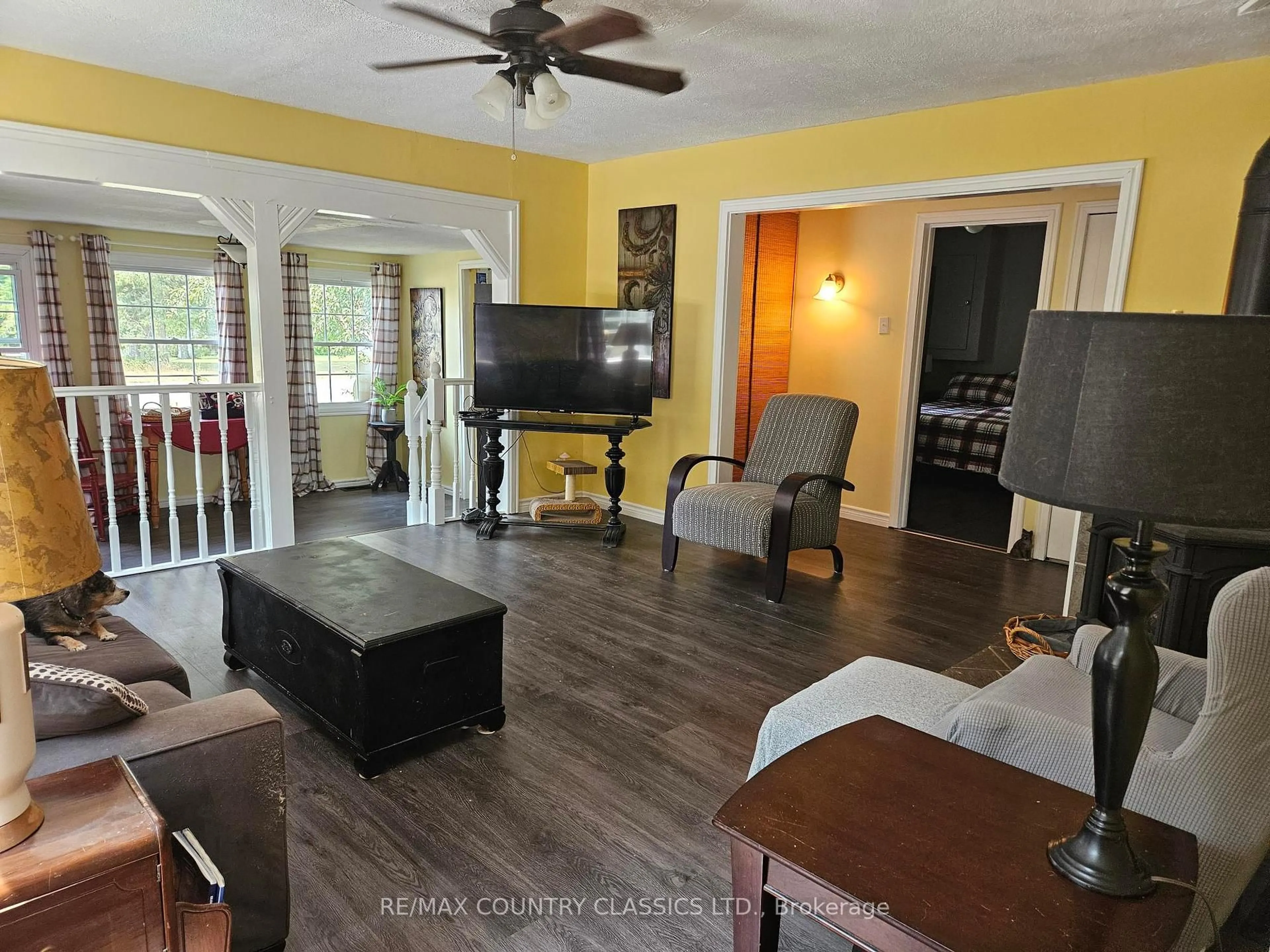 Living room with furniture, wood/laminate floor for 39 Lake St, South Algonquin Ontario K0J 2M0