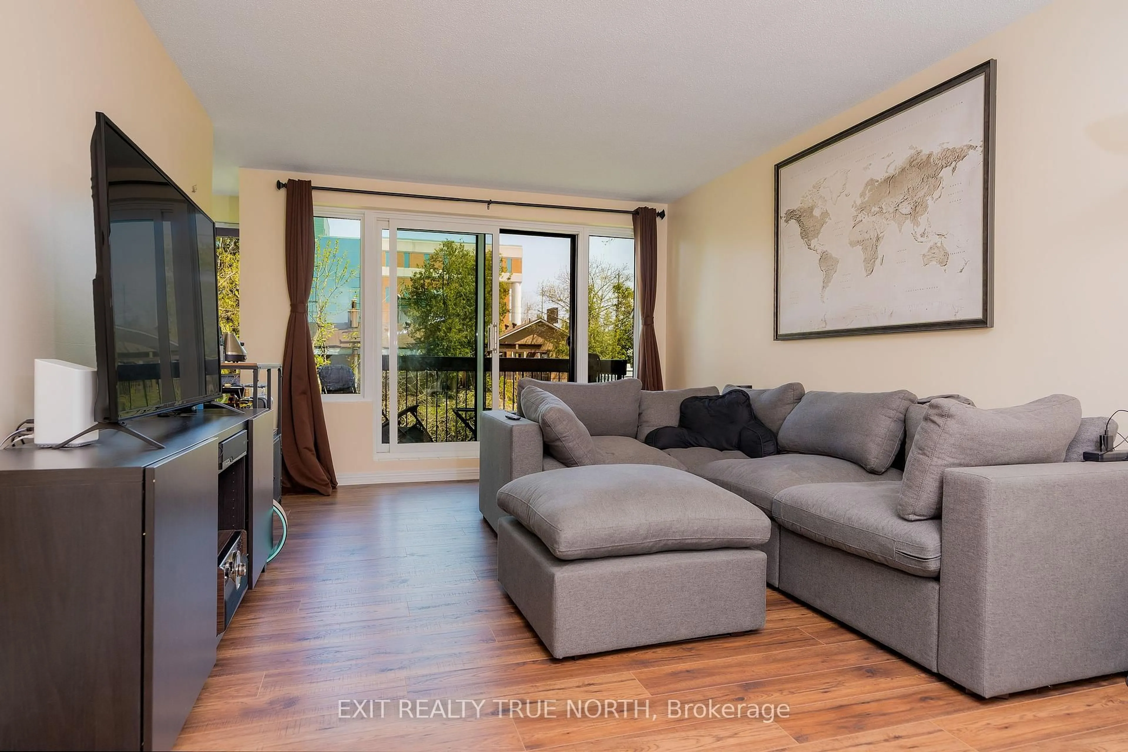 Living room with furniture, wood/laminate floor for 850 6th St #204, Owen Sound Ontario N4K 6T7