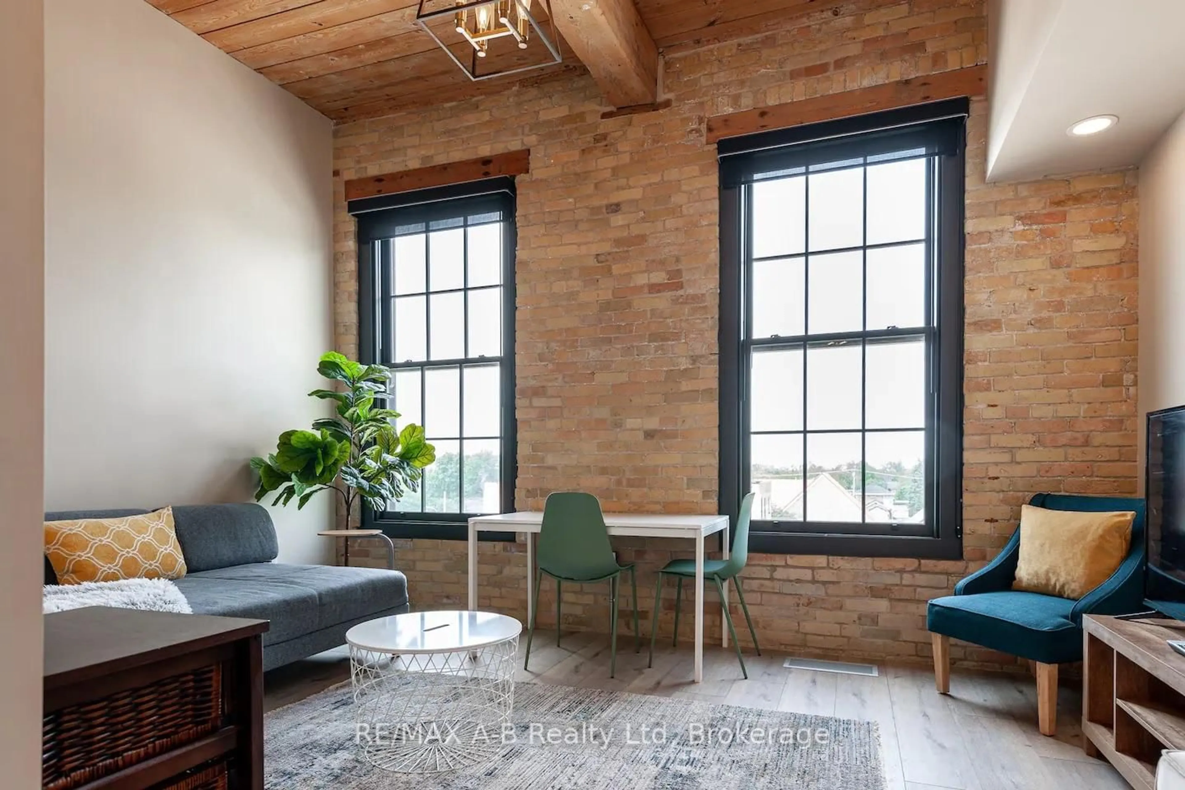 Living room with furniture, wood/laminate floor for 245 Downie St #208, Stratford Ontario N5A 1X5