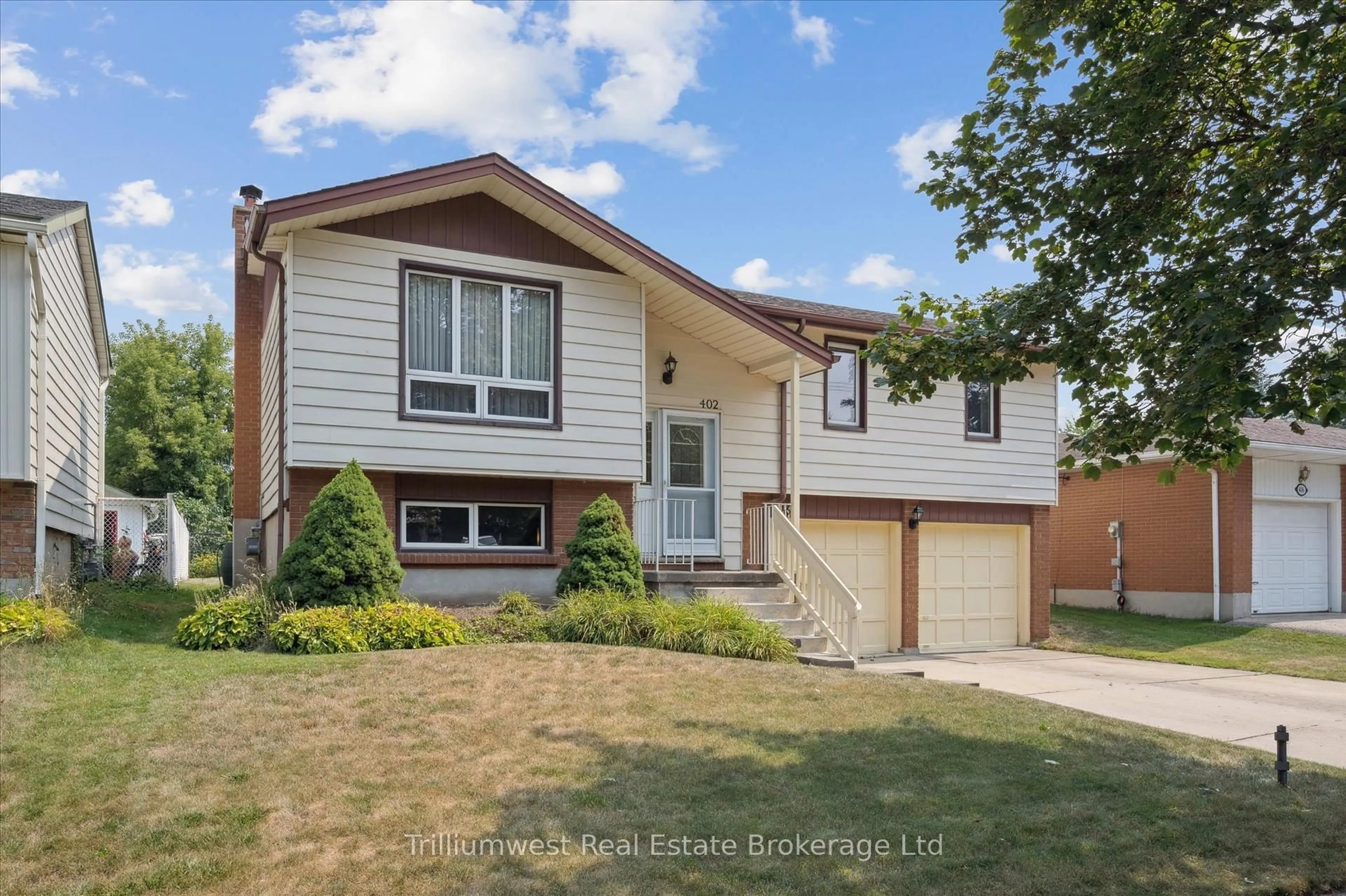 Home with vinyl exterior material, street for 402 Heritage Dr, Kitchener Ontario N2B 3M9