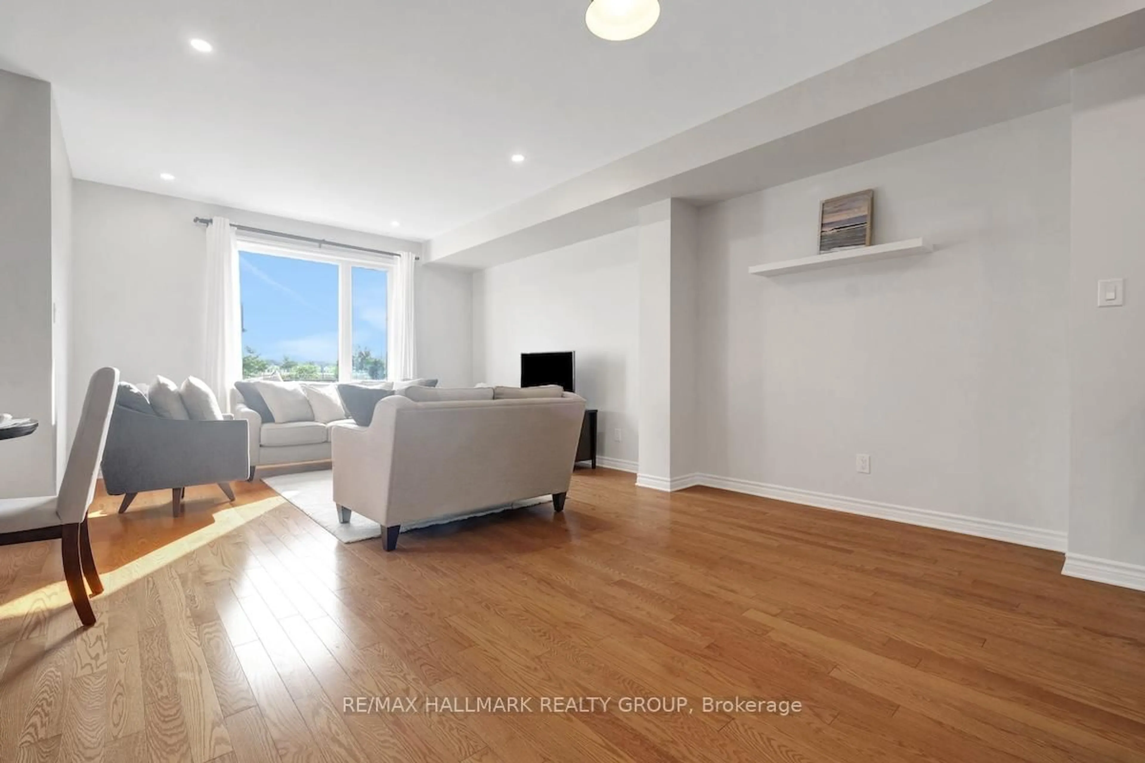 Living room with furniture, wood/laminate floor for 199A Shinny Ave, Ottawa Ontario K2V 0E9