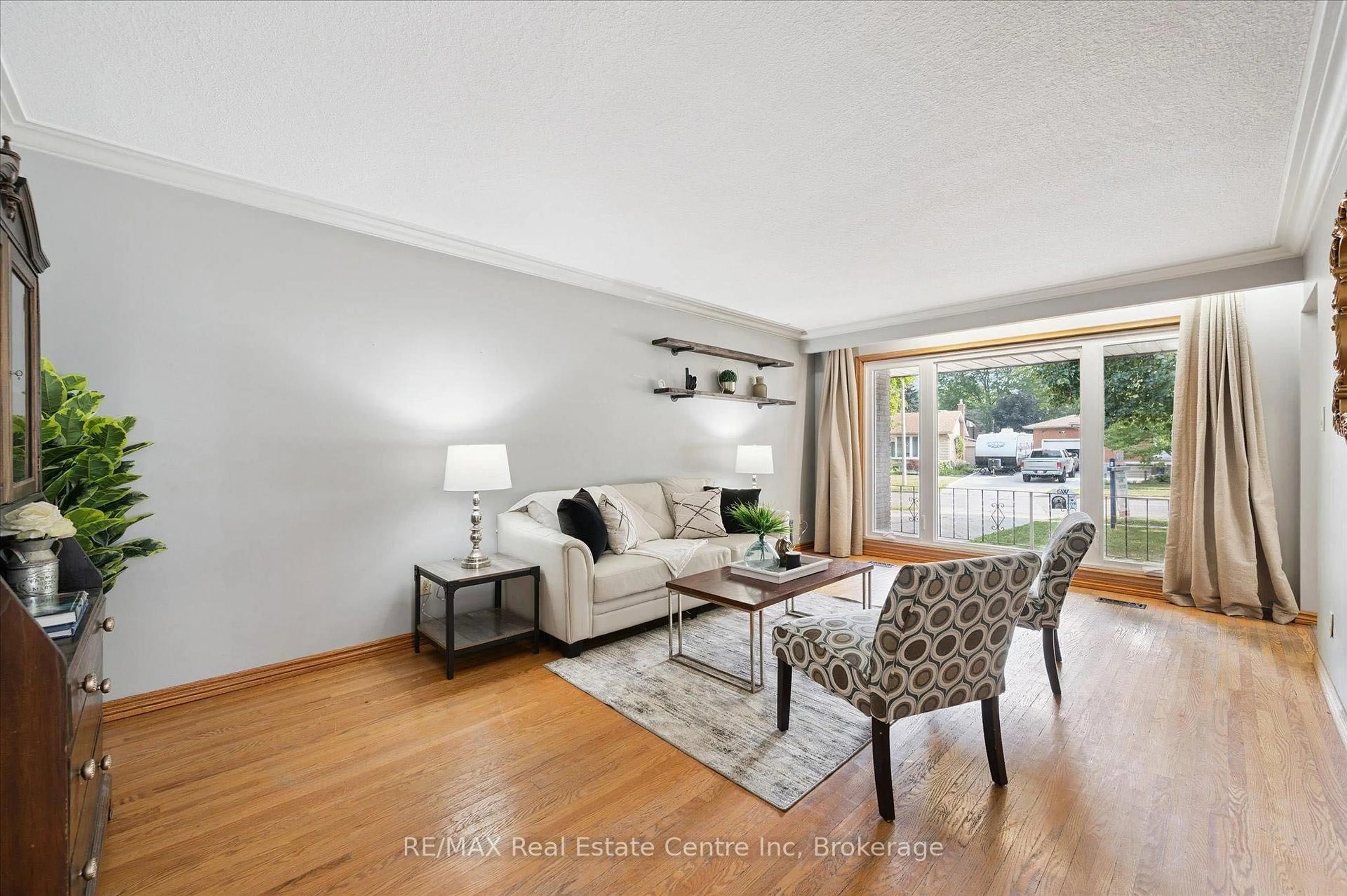 Living room with furniture, wood/laminate floor for 69 Rhonda Rd, Guelph Ontario N1H 6H3