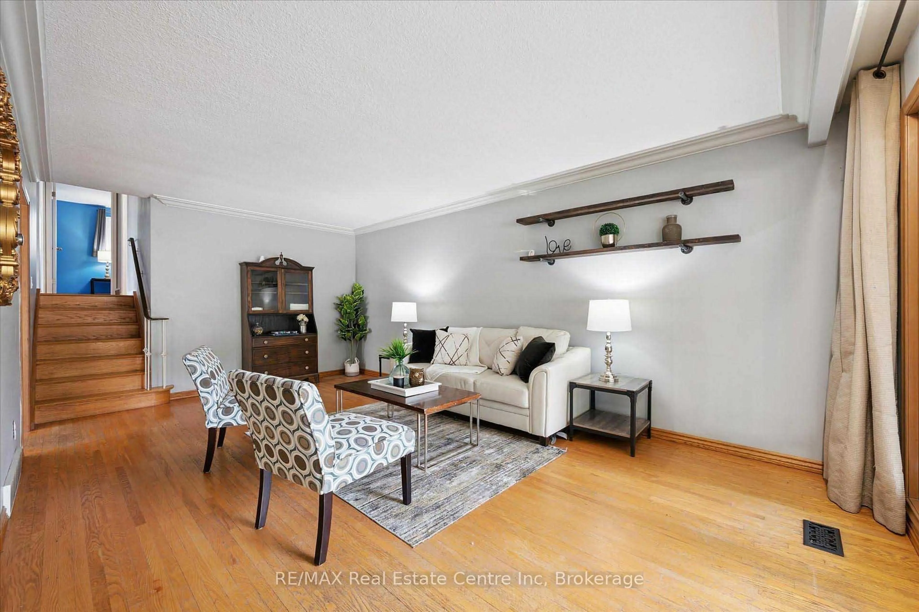 Living room with furniture, wood/laminate floor for 69 Rhonda Rd, Guelph Ontario N1H 6H3