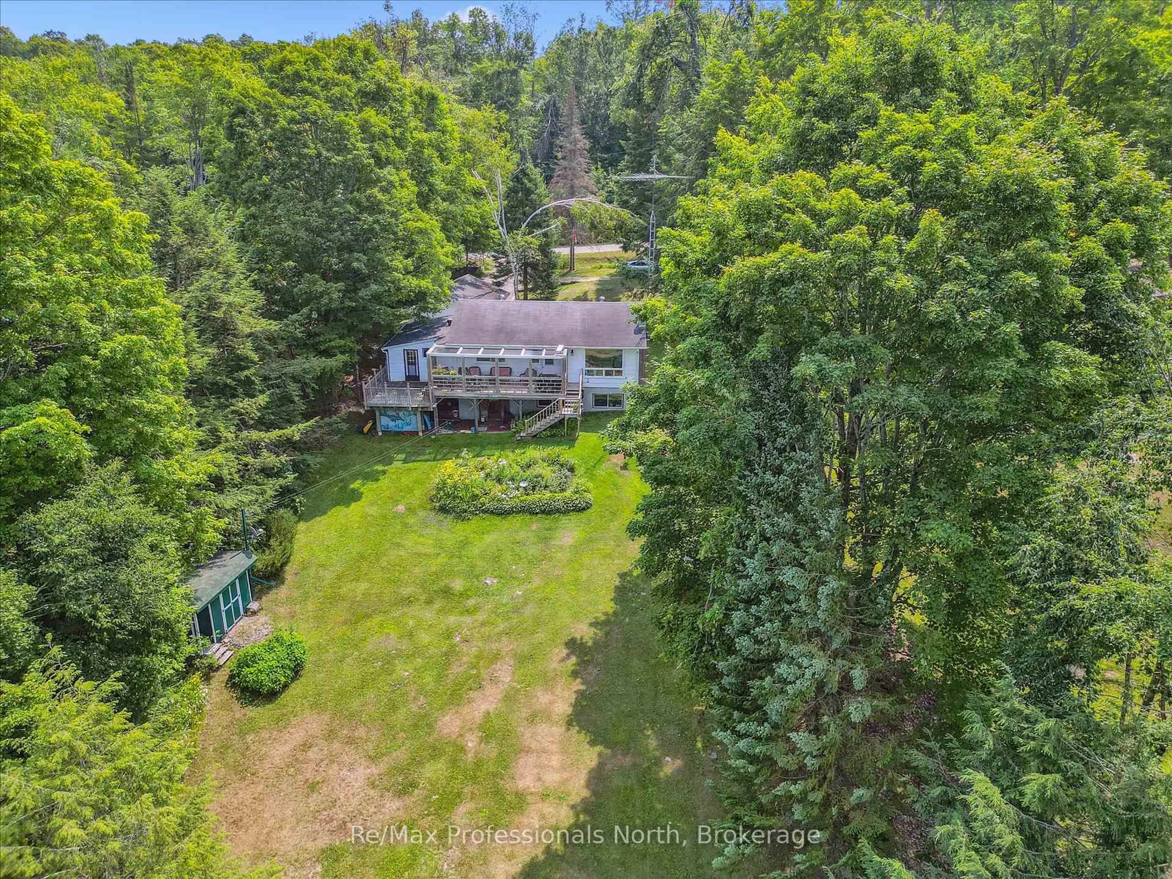 A pic from outside/outdoor area/front of a property/back of a property/a pic from drone, water/lake/river/ocean view for 1042 River Haven Rd, Bracebridge Ontario P1L 1X1