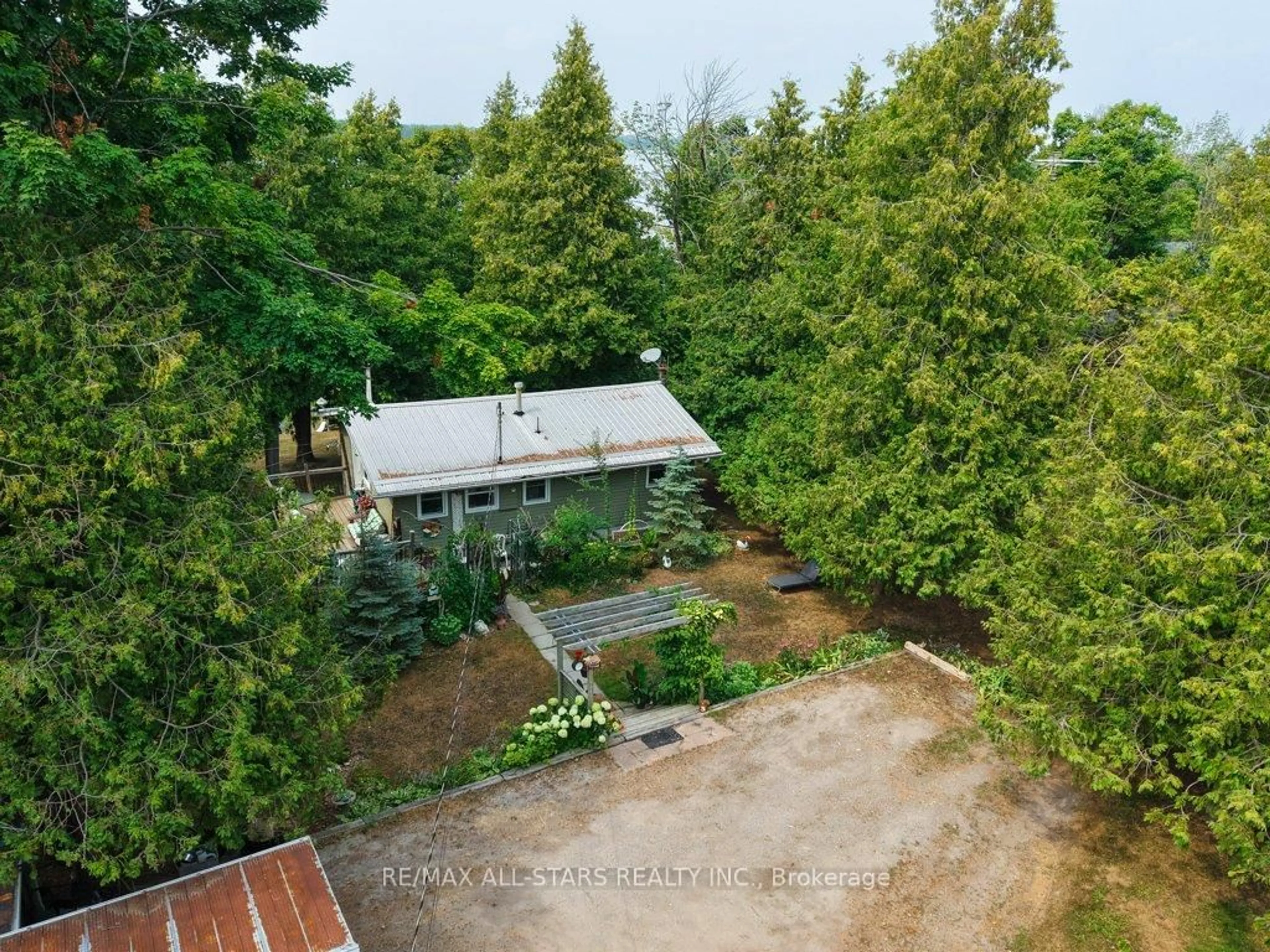 A pic from outside/outdoor area/front of a property/back of a property/a pic from drone, forest/trees view for 6 Leisure Lane, Kawartha Lakes Ontario K9V 4R1