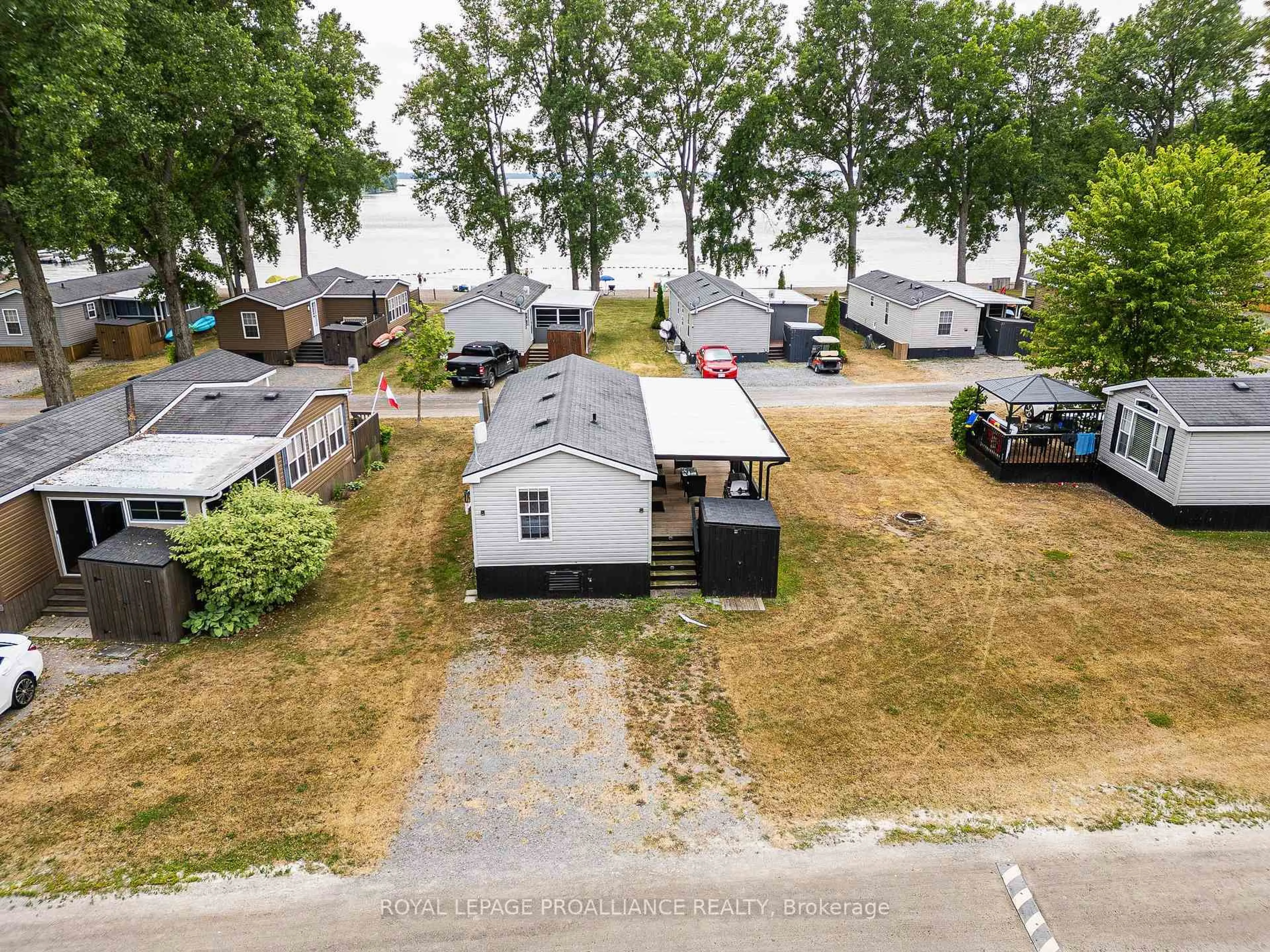 A pic from outside/outdoor area/front of a property/back of a property/a pic from drone, water/lake/river/ocean view for 486 County Road 18 #26 Beach View Lane, Prince Edward County Ontario K0K 1P0
