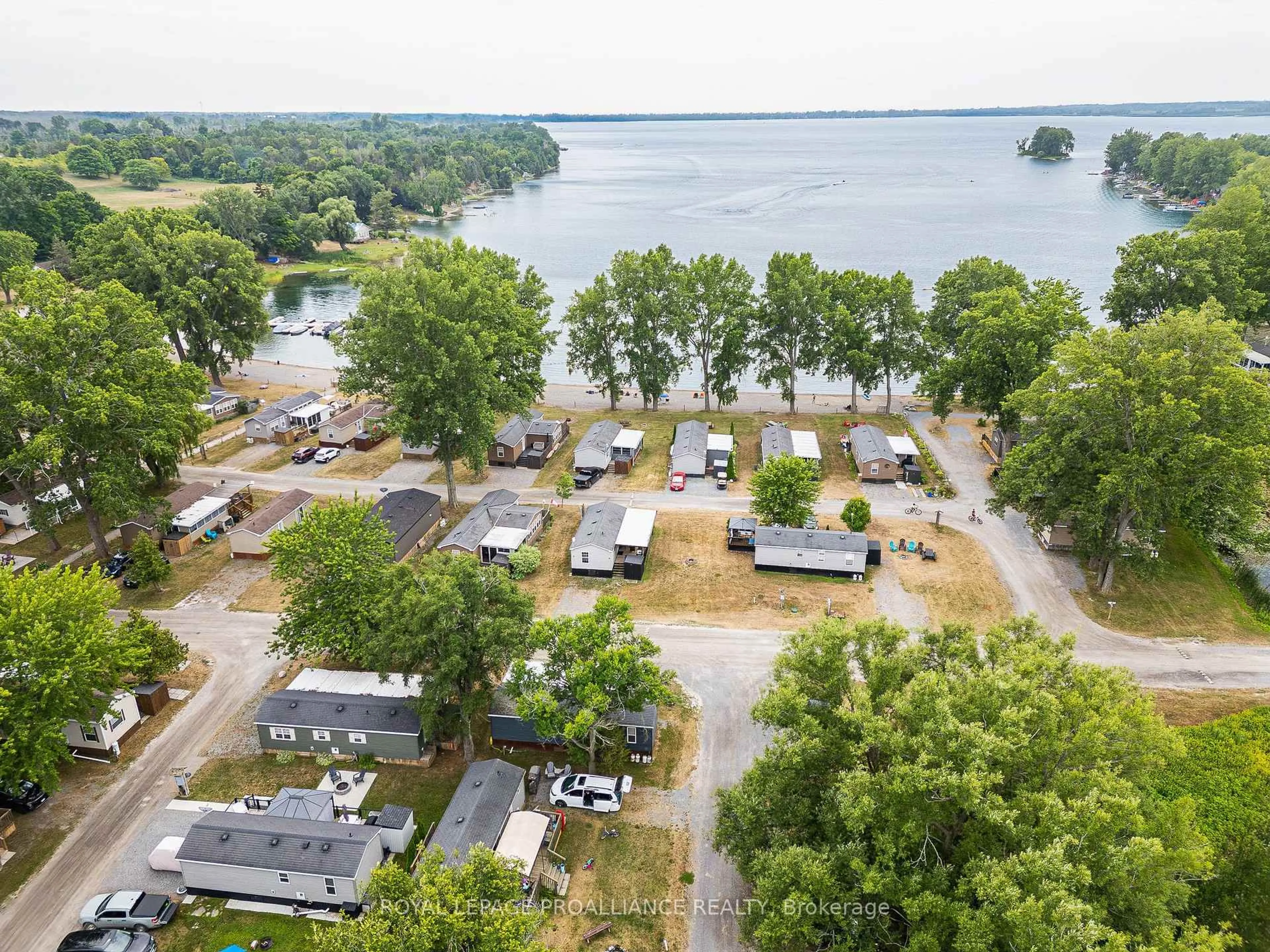 A pic from outside/outdoor area/front of a property/back of a property/a pic from drone, water/lake/river/ocean view for 486 County Road 18 #26 Beach View Lane, Prince Edward County Ontario K0K 1P0