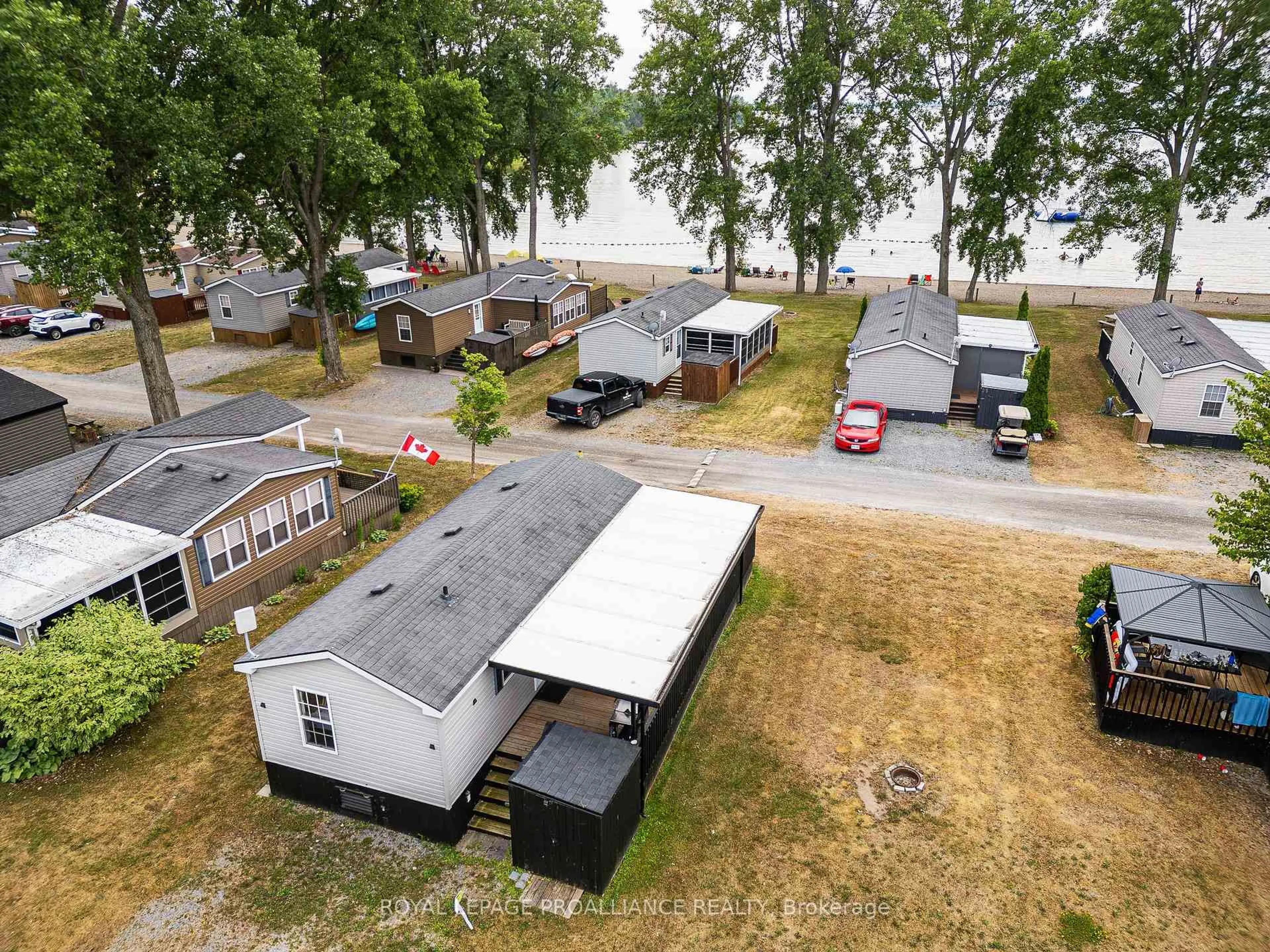 A pic from outside/outdoor area/front of a property/back of a property/a pic from drone, water/lake/river/ocean view for 486 County Road 18 #26 Beach View Lane, Prince Edward County Ontario K0K 1P0