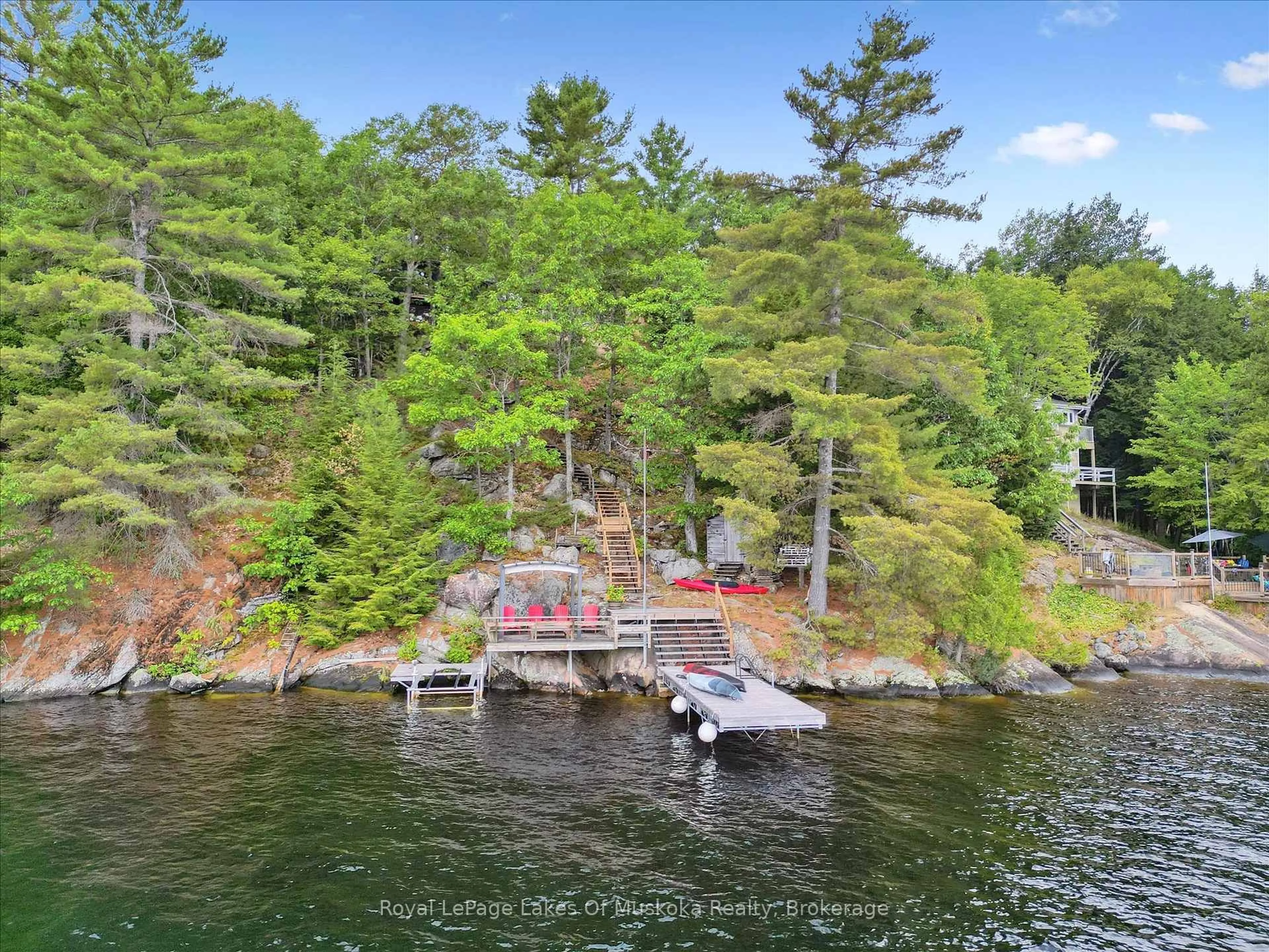A pic from outside/outdoor area/front of a property/back of a property/a pic from drone, water/lake/river/ocean view for 219 Rowanwood Lane, Huntsville Ontario P0B 1M0