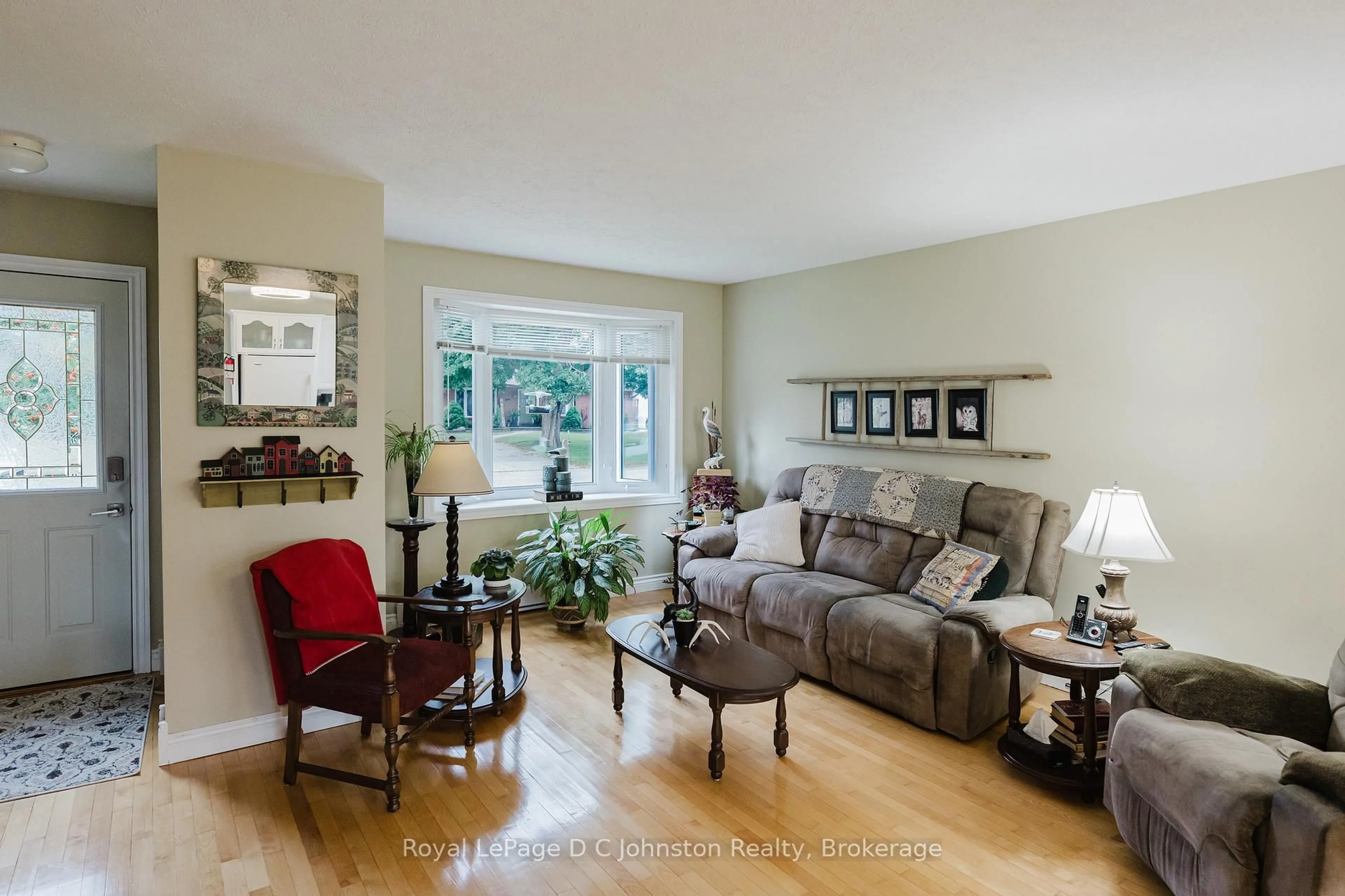 Living room with furniture, wood/laminate floor for 477 Wales Dr, Saugeen Shores Ontario N0H 2C1