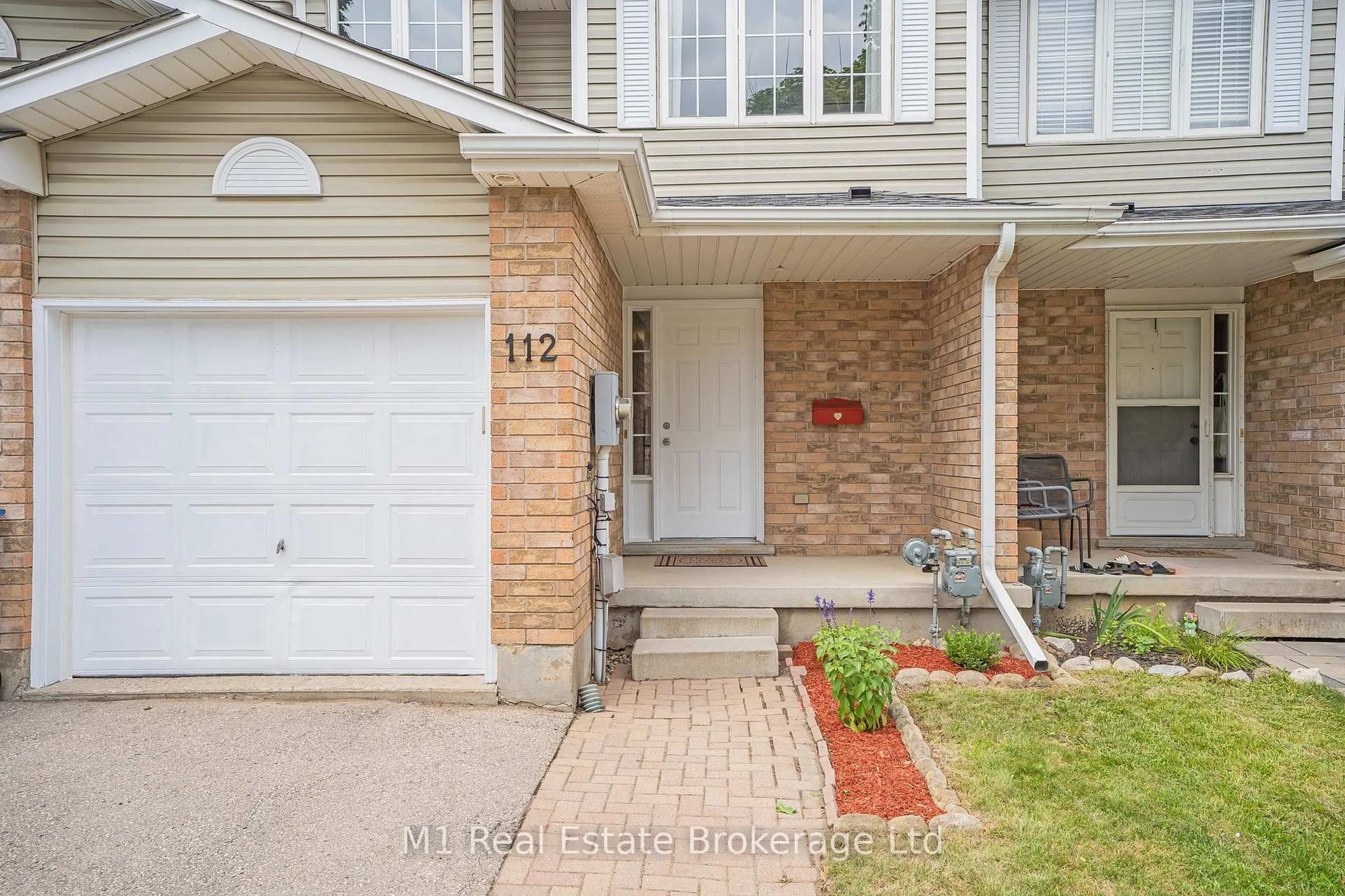 Home with brick exterior material, street for 112 Chesterton Lane, Guelph Ontario N1E 7B8