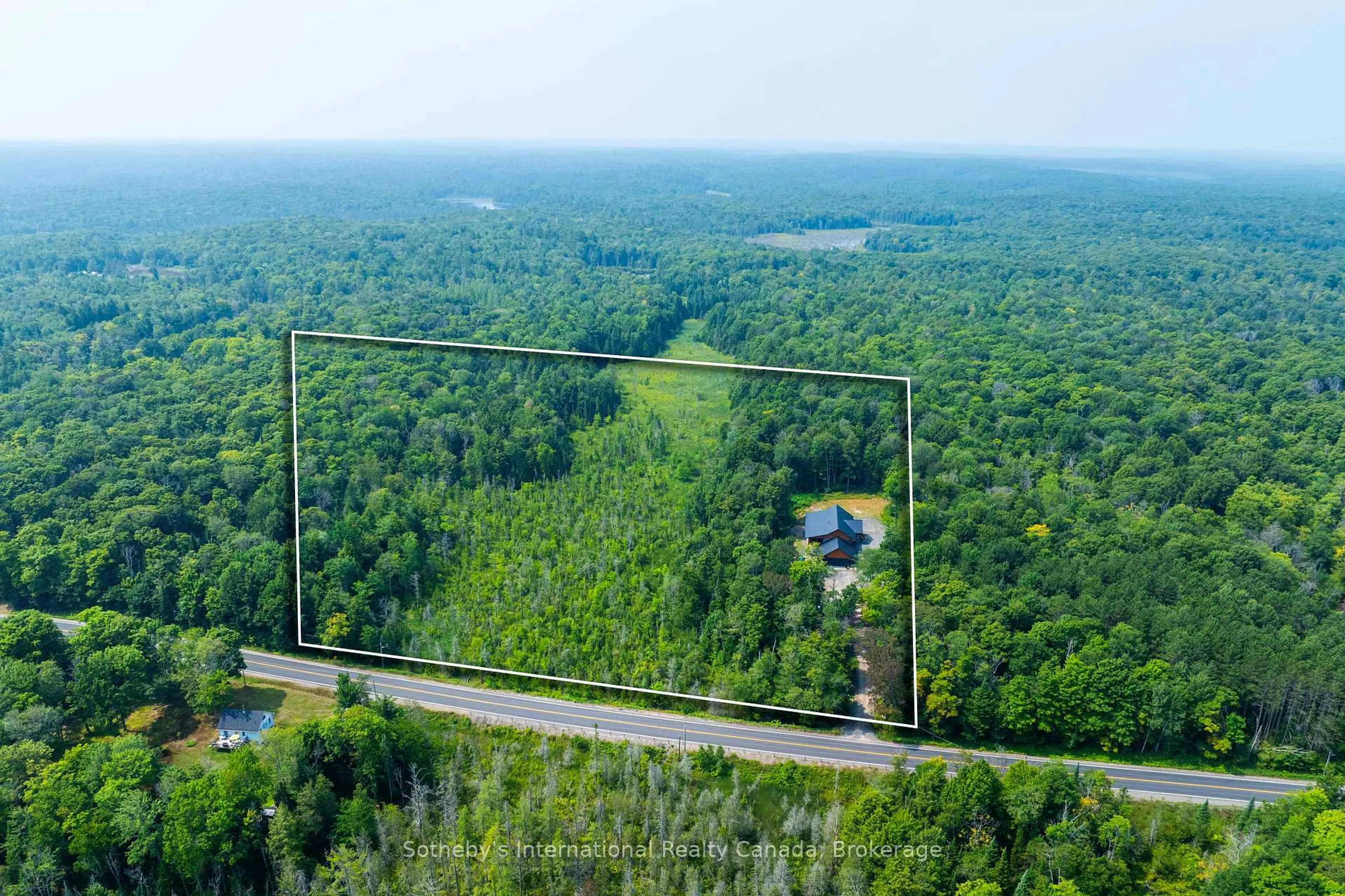 A pic from outside/outdoor area/front of a property/back of a property/a pic from drone, forest/trees view for 2749 Brunel Rd, Huntsville Ontario P1H 2J3