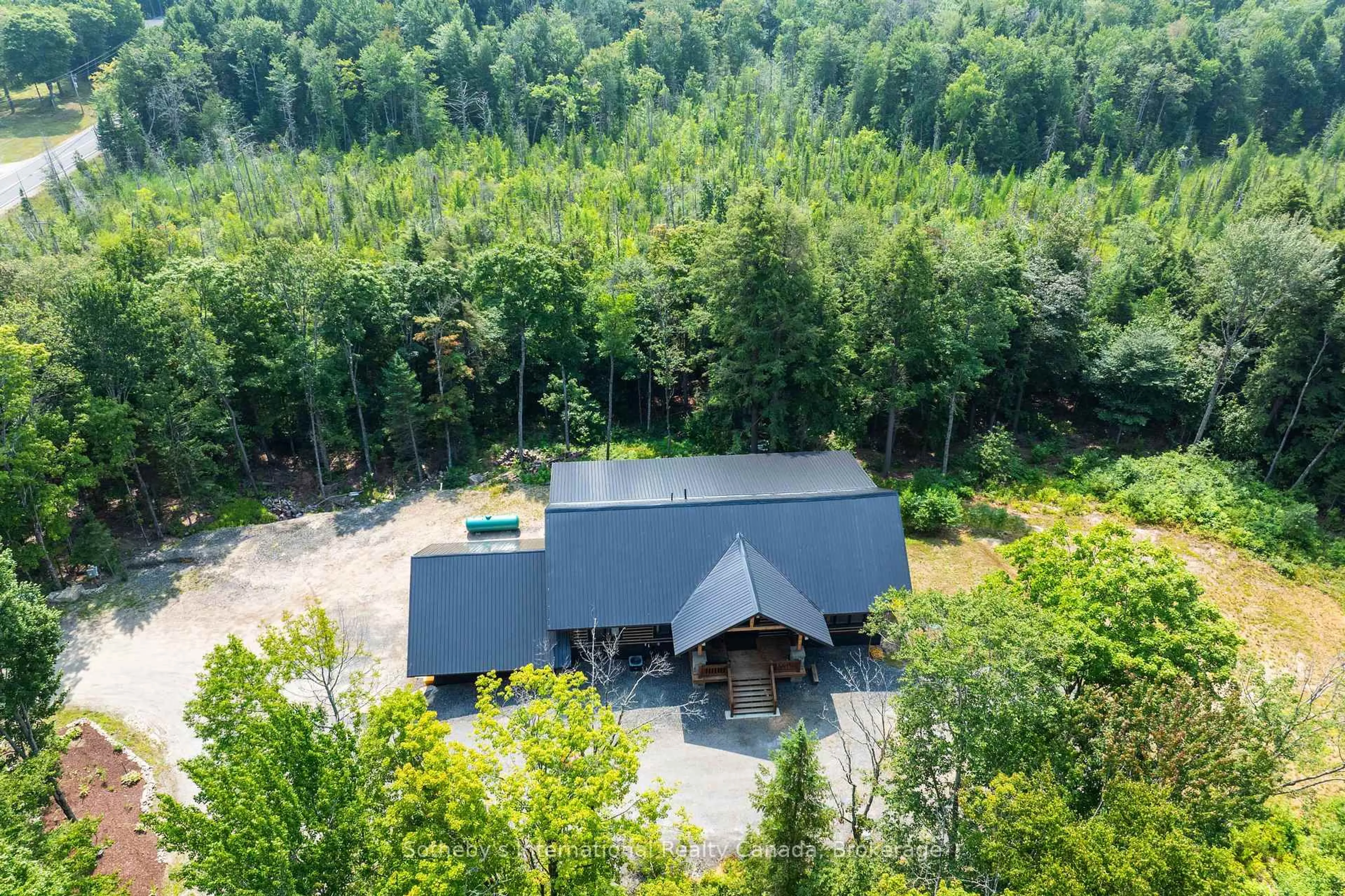 A pic from outside/outdoor area/front of a property/back of a property/a pic from drone, forest/trees view for 2749 Brunel Rd, Huntsville Ontario P1H 2J3