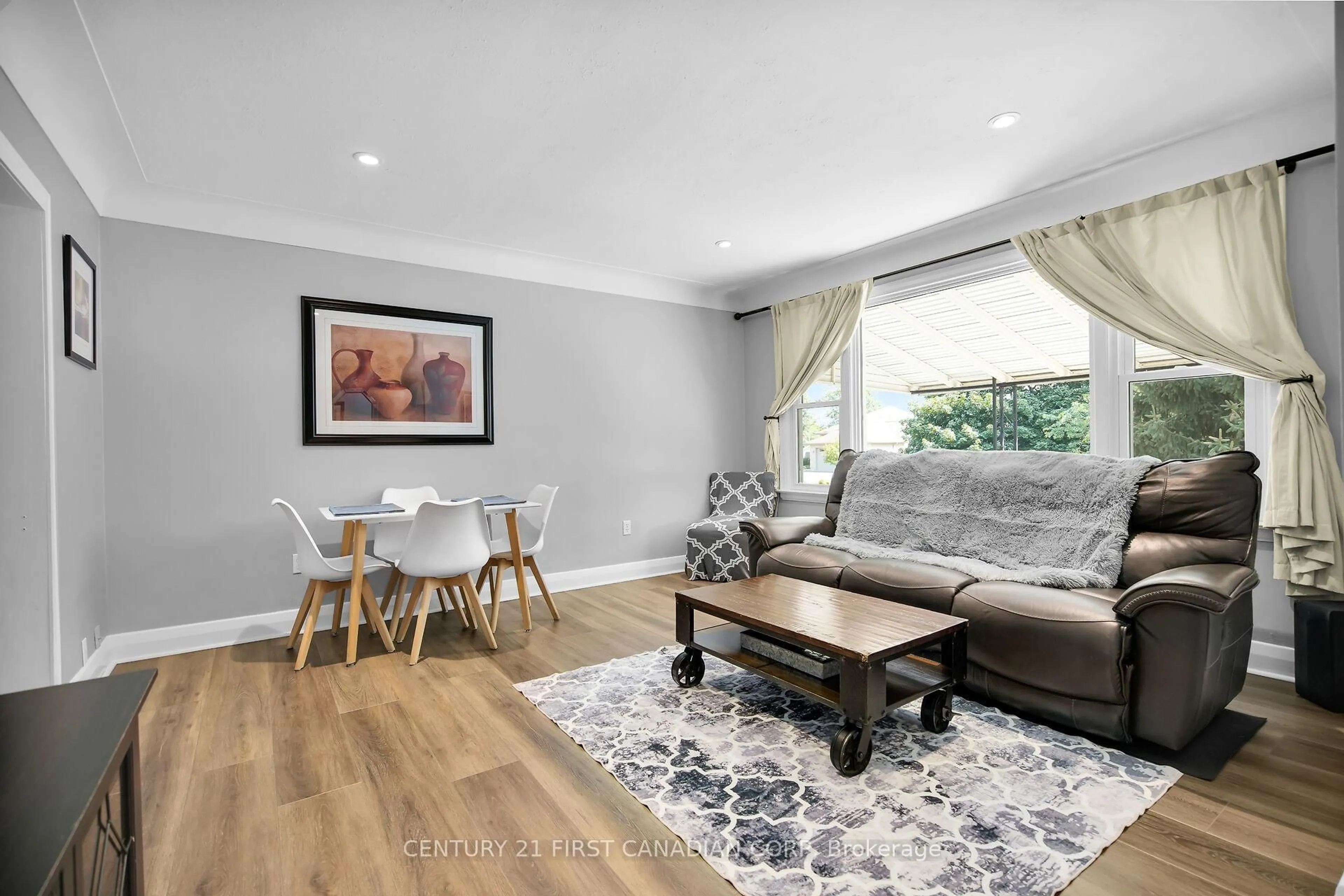 Living room with furniture, wood/laminate floor for 568 Creston Ave, London South Ontario N6C 3A6