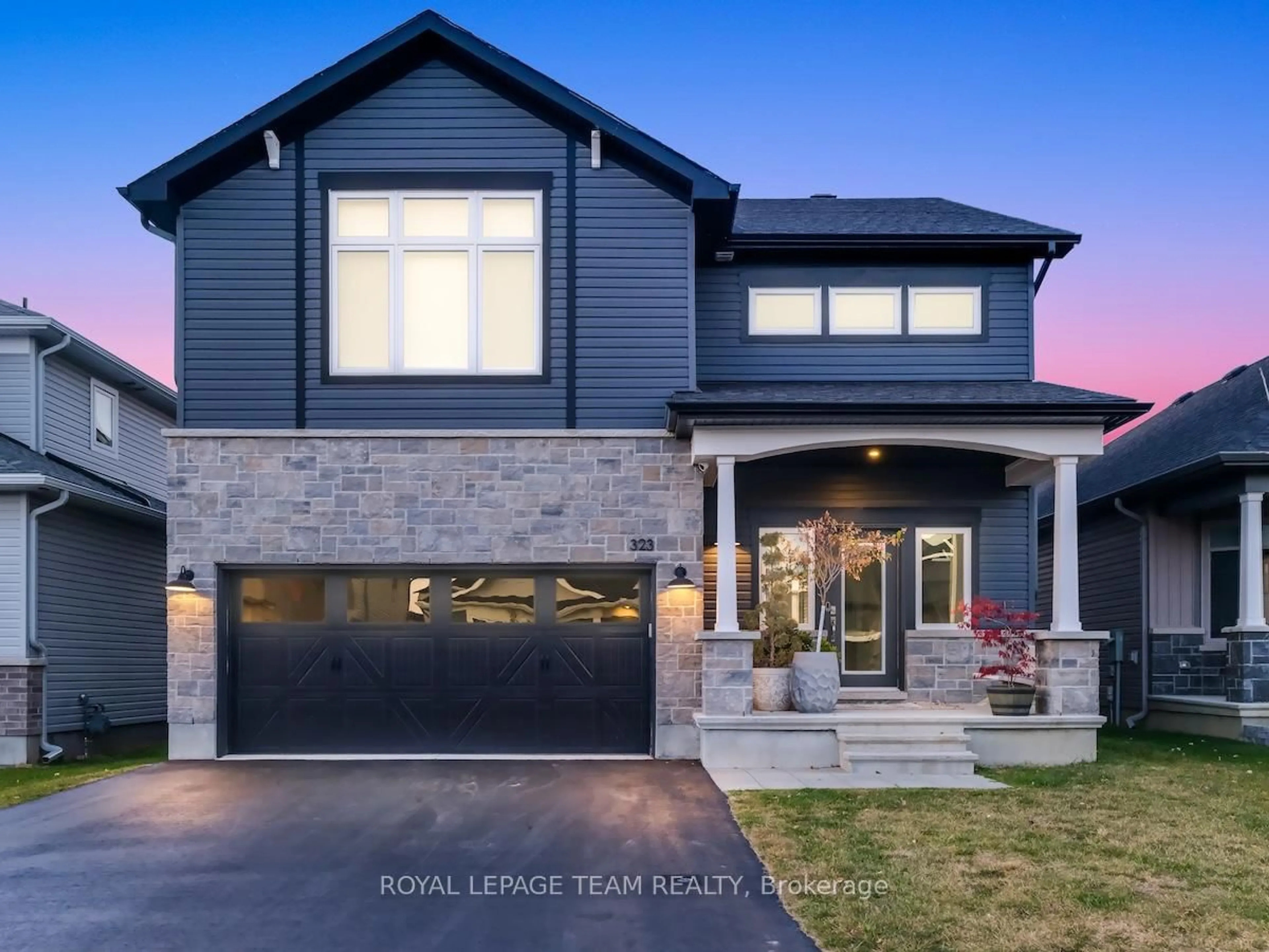 Home with brick exterior material, street for 323 Spreadwing Way, Ottawa Ontario K1X 0J5