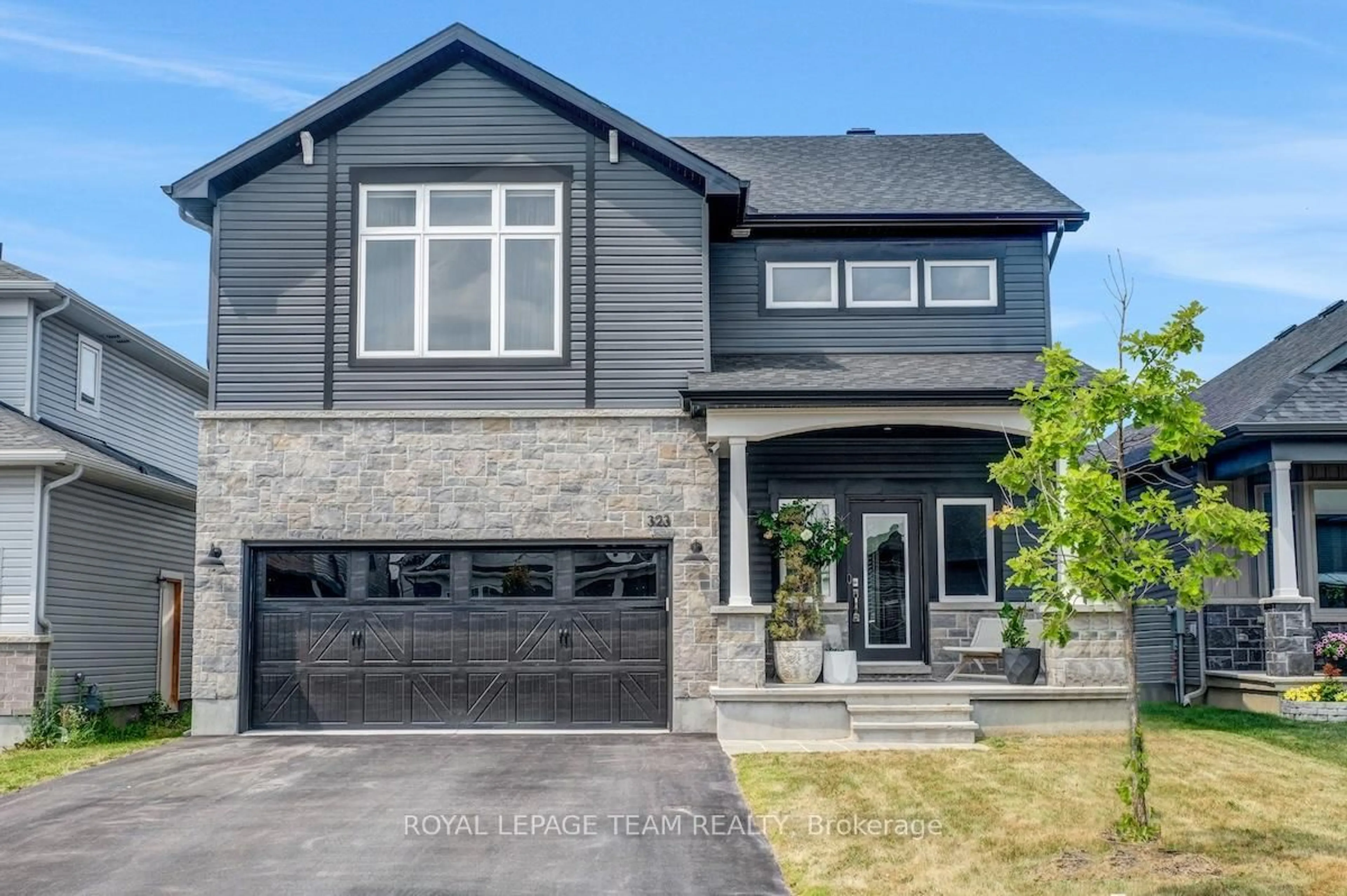 Home with brick exterior material, street for 323 Spreadwing Way, Ottawa Ontario K1X 0J5