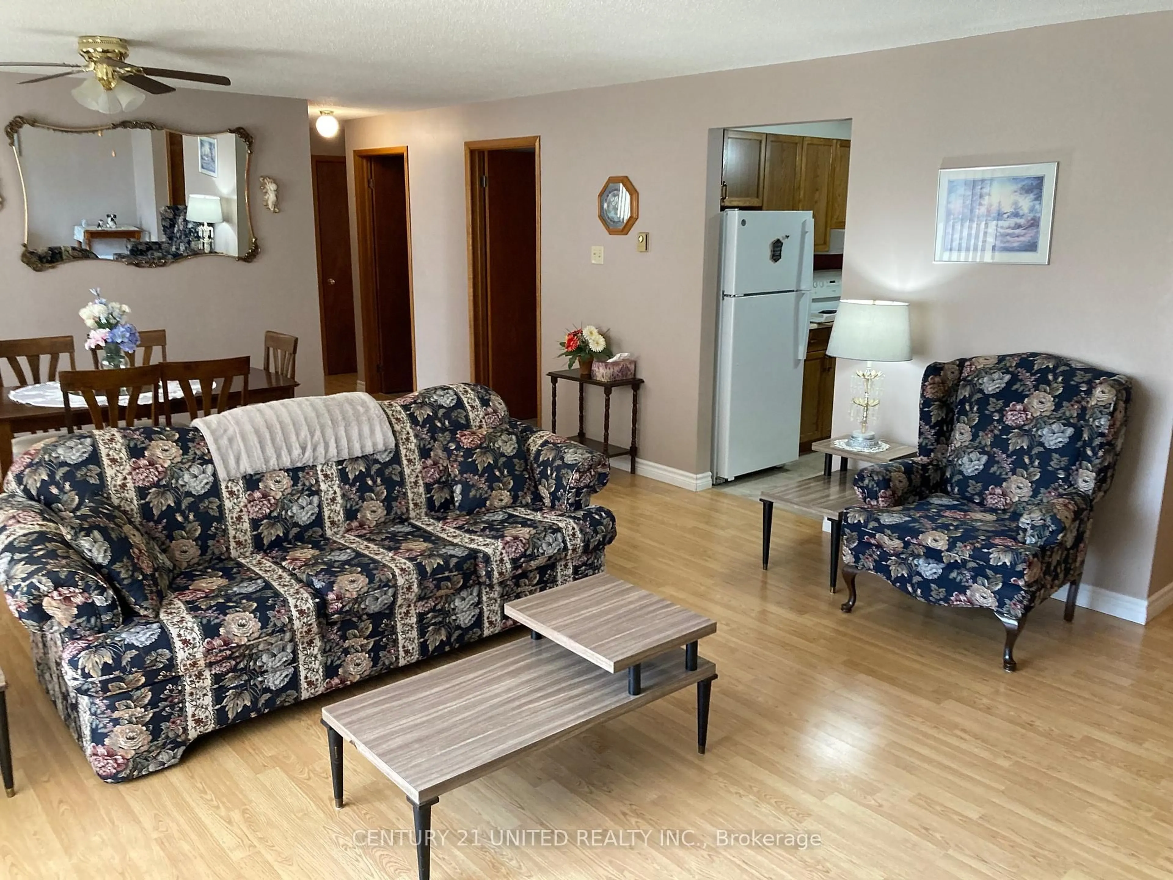 Living room with furniture, wood/laminate floor for 2418 Mountland Dr #102, Peterborough West Ontario K9K 2E2
