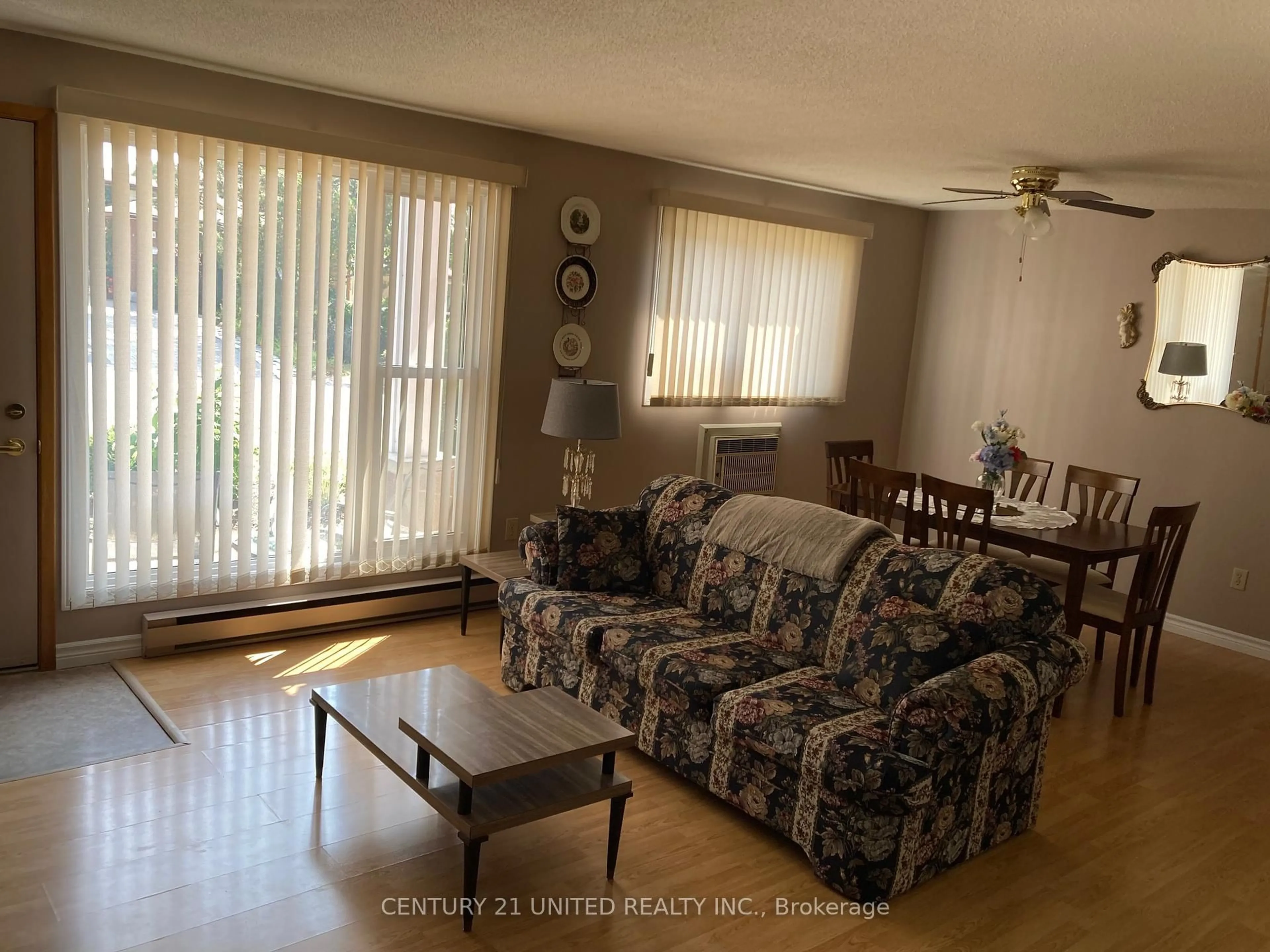 Living room with furniture, wood/laminate floor for 2418 Mountland Dr #102, Peterborough West Ontario K9K 2E2