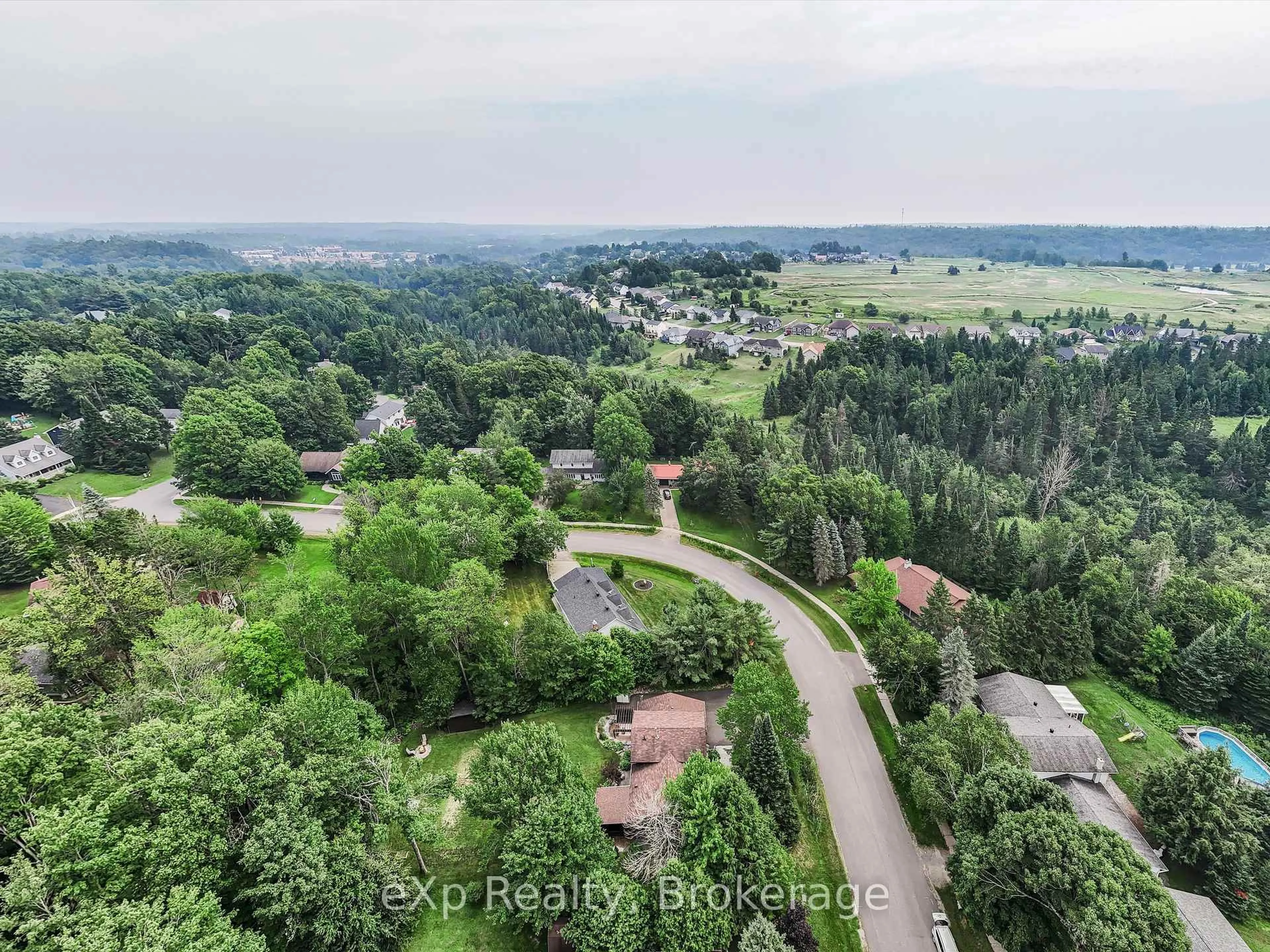 A pic from outside/outdoor area/front of a property/back of a property/a pic from drone, forest/trees view for 104 Meadow Heights Dr, Bracebridge Ontario P1L 1A4