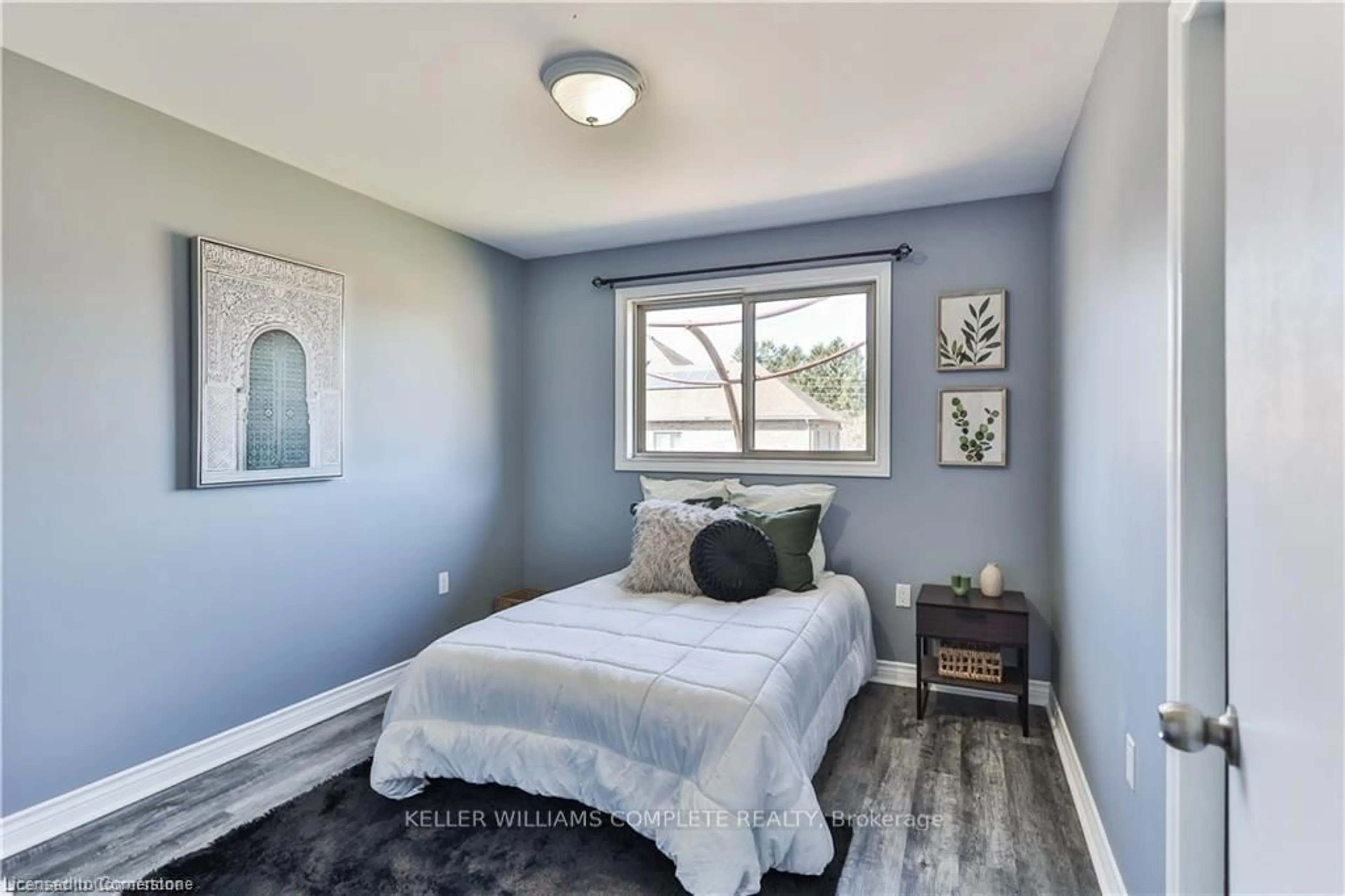 Bedroom with bed, wood/laminate floor for 98 THOMAS Ave, Brantford Ontario N3S 7V4