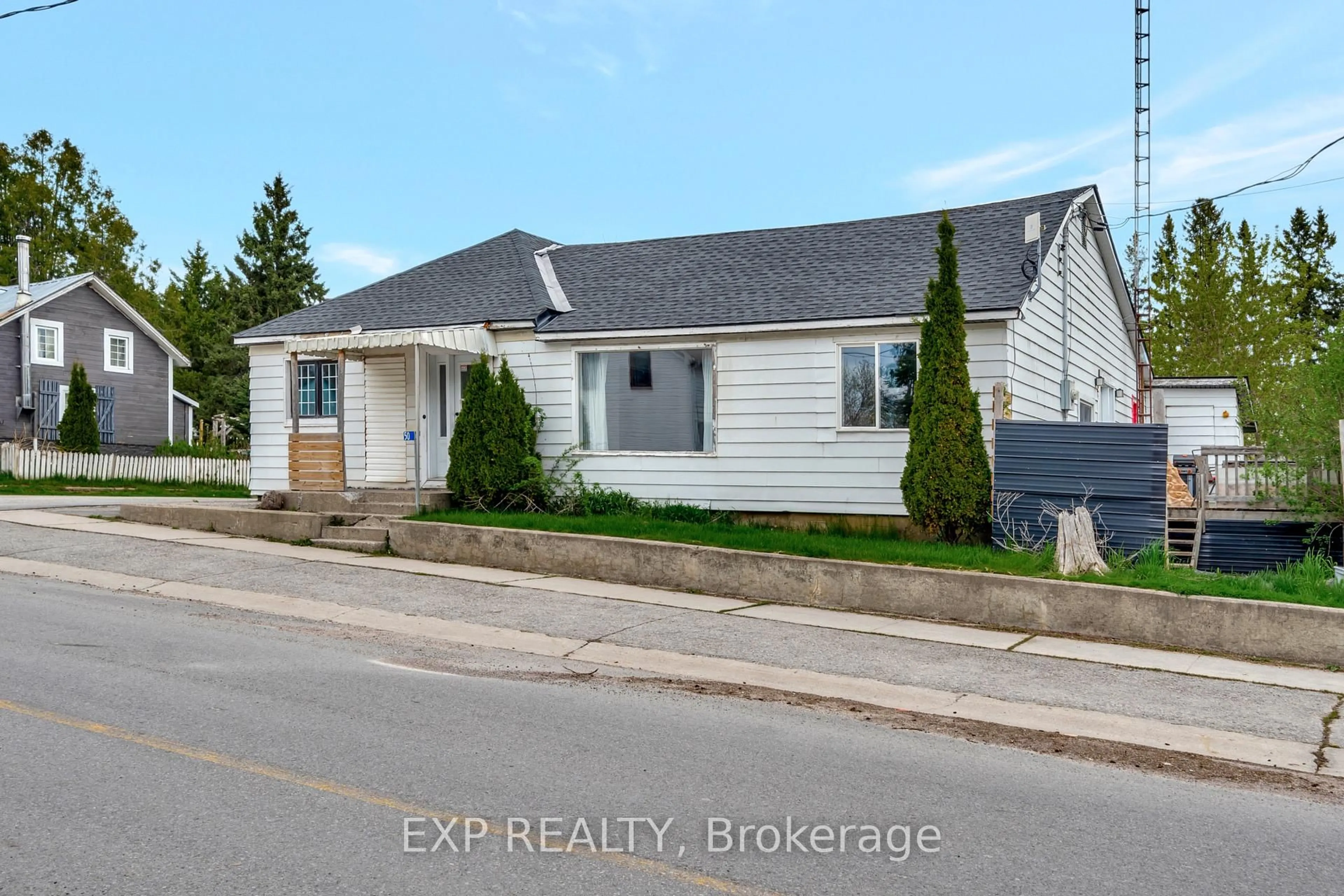 Home with vinyl exterior material, street for 50 Queen St, Tweed Ontario K0K 2L0