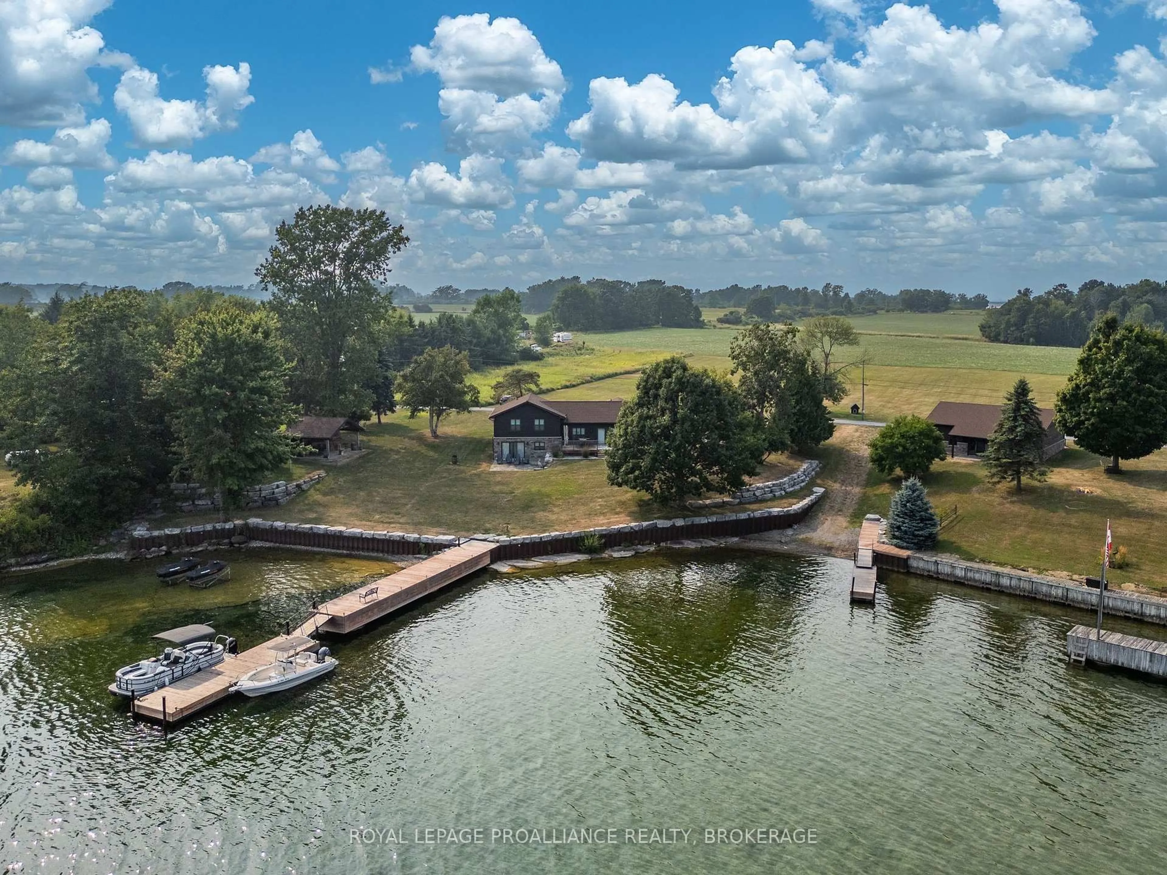 A pic from outside/outdoor area/front of a property/back of a property/a pic from drone, water/lake/river/ocean view for 199 & 213 Leone's Cove Lane, Wolfe Island Ontario K0H 2Y0