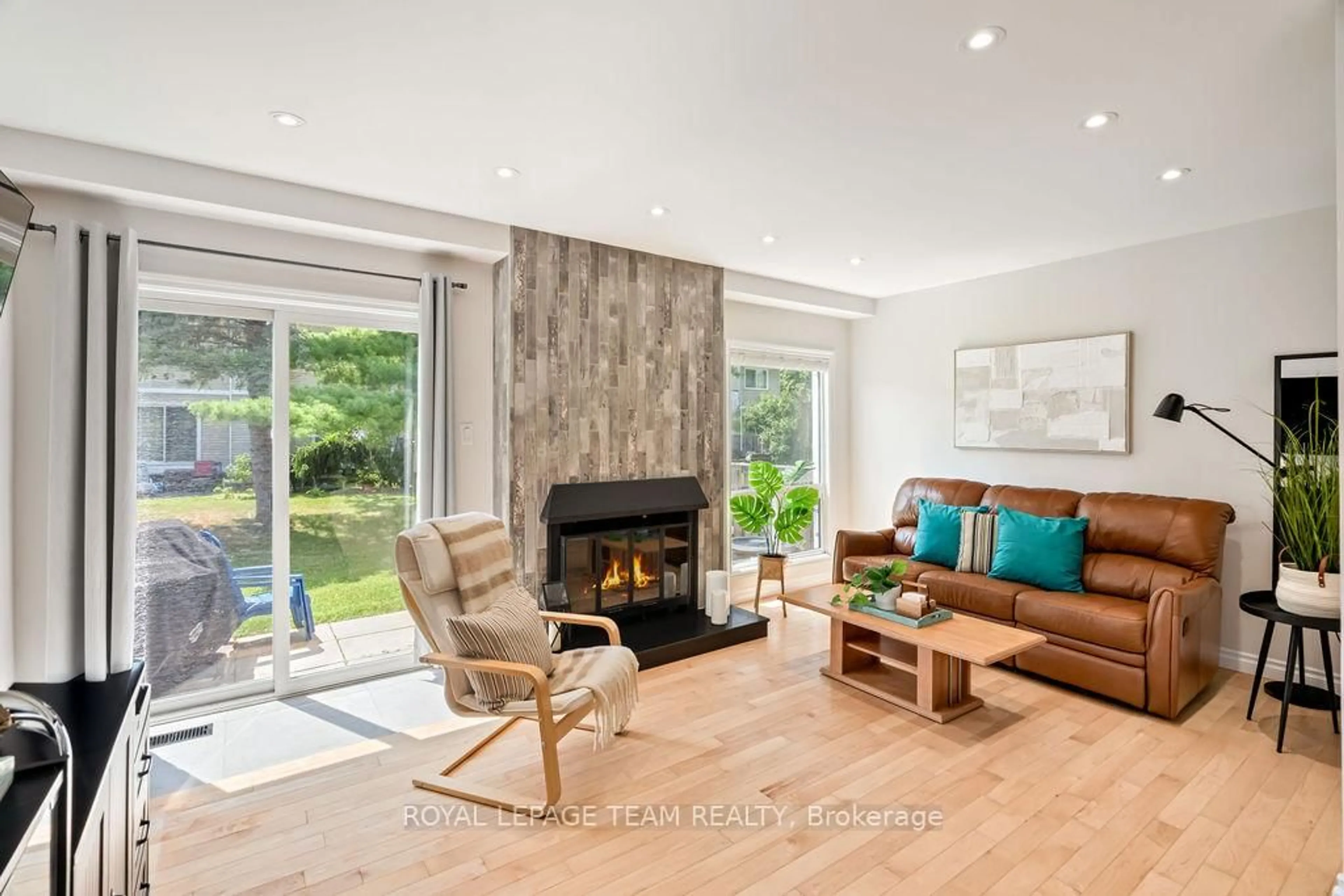 Living room with furniture, wood/laminate floor for 177 Valley Stream Dr #A, Ottawa Ontario K2H 9C7