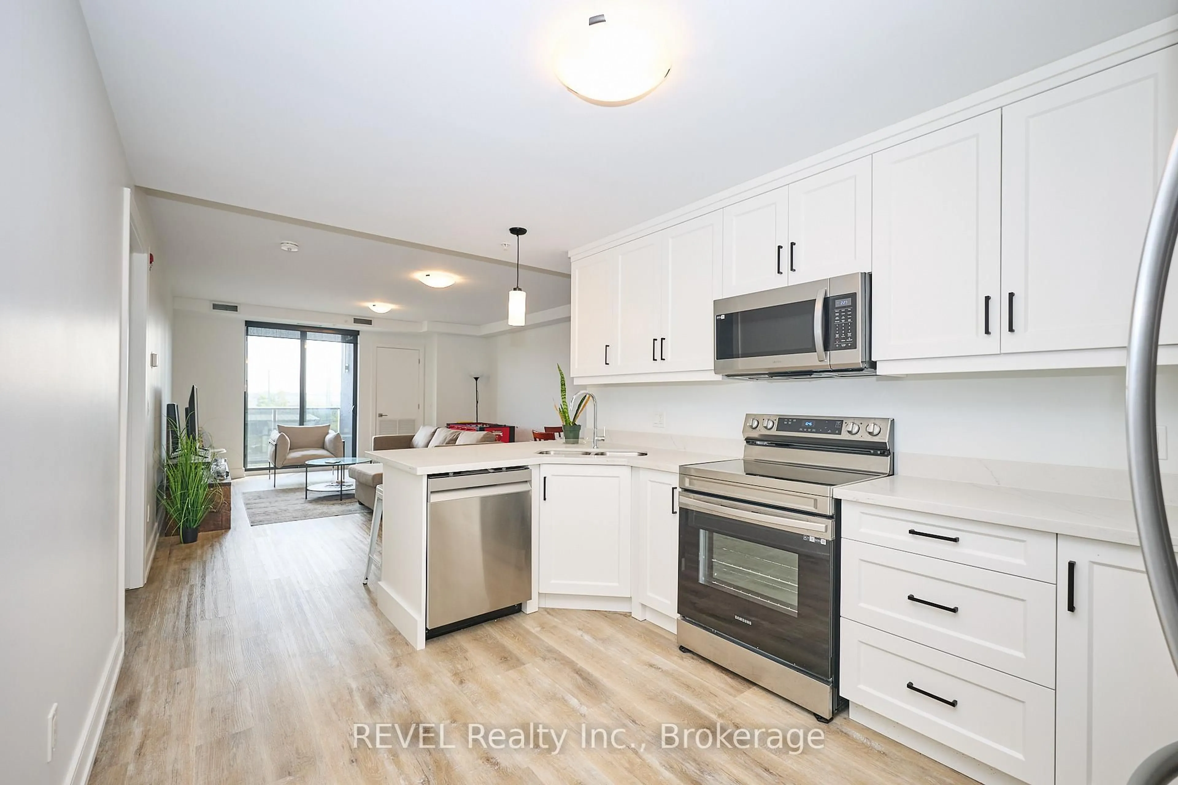 Open concept kitchen, wood/laminate floor for 300B Fourth Ave #305, St. Catharines Ontario L2S 0E6