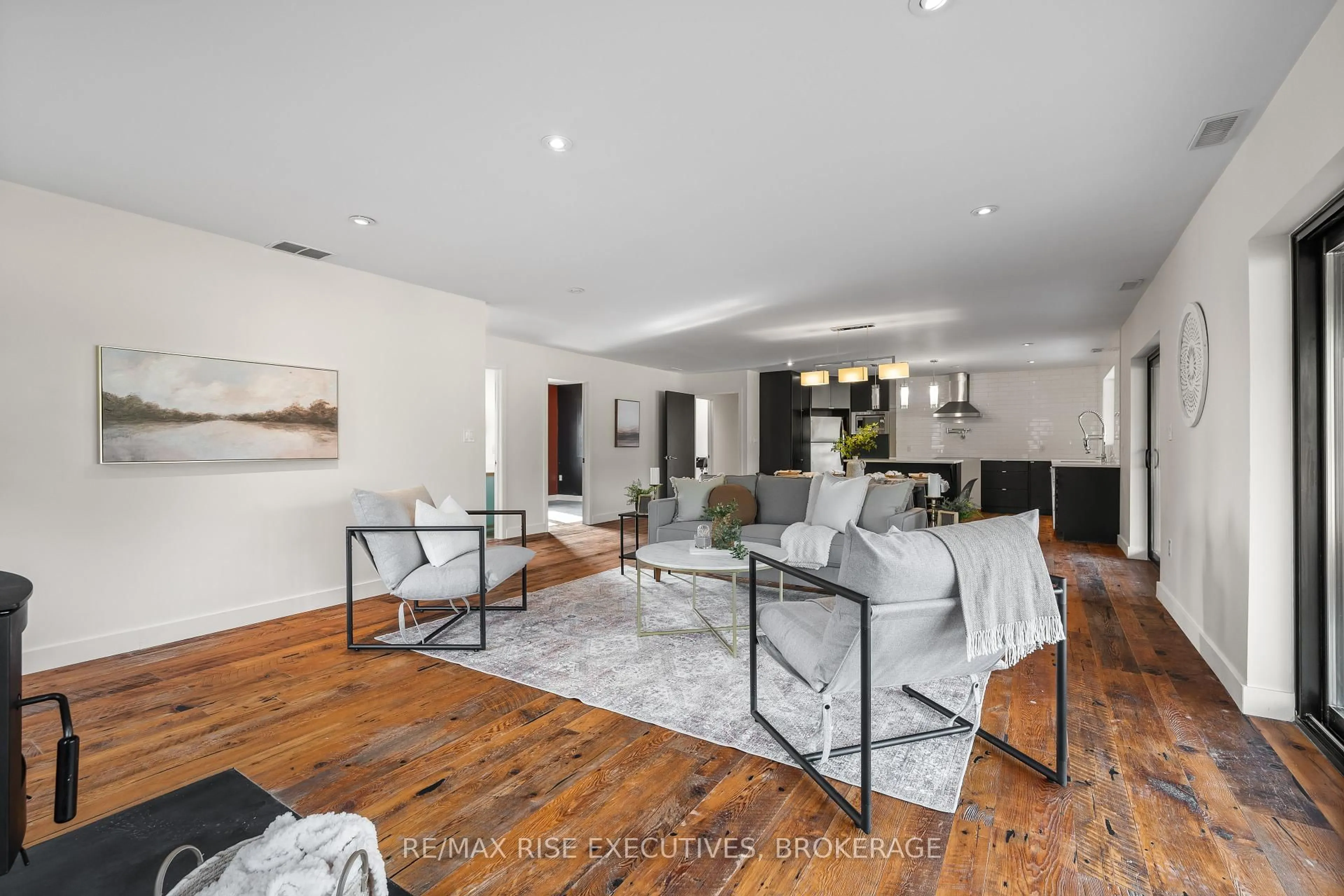 Living room with furniture, wood/laminate floor for 2621 County Road 6 Rd, Yarker Ontario K0K 3N0