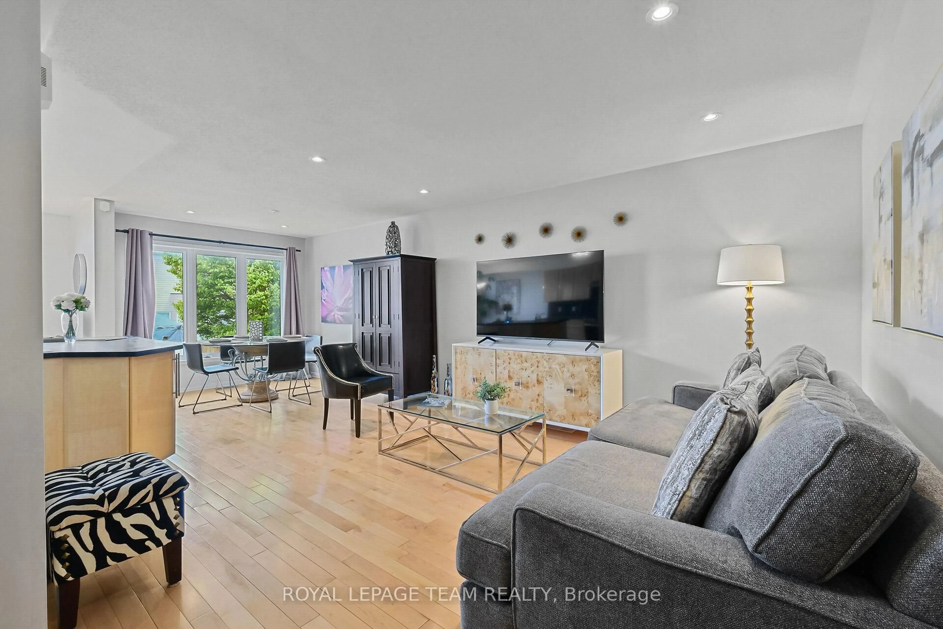 Living room with furniture, wood/laminate floor for 2072 Dunollie Cres, Ottawa Ontario K2W 1H6