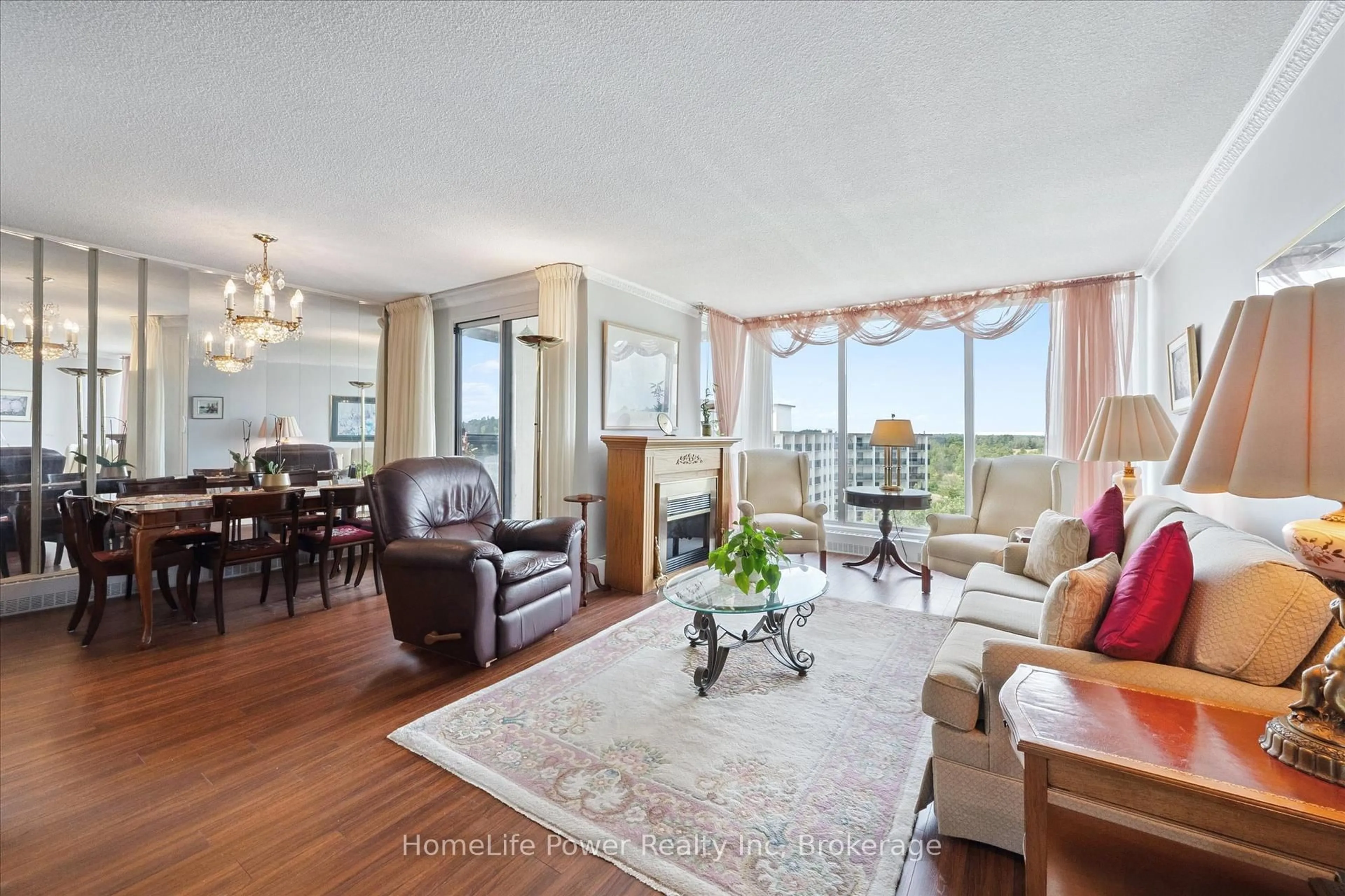Living room with furniture, wood/laminate floor for 19 Woodlawn Rd #711, Guelph Ontario N1H 7B1