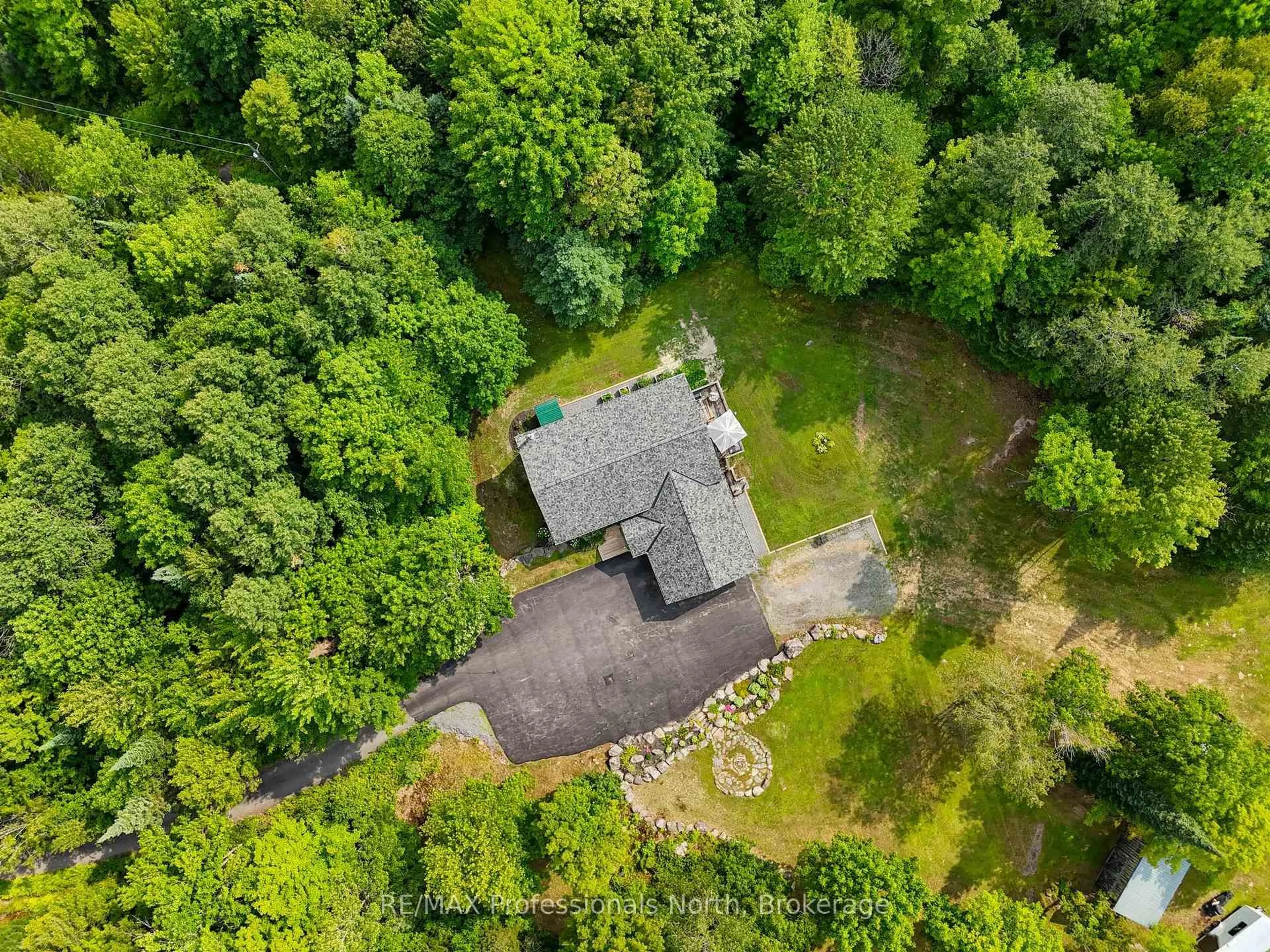 A pic from outside/outdoor area/front of a property/back of a property/a pic from drone, forest/trees view for 1658 60 Highway, Huntsville Ontario P1H 1A2