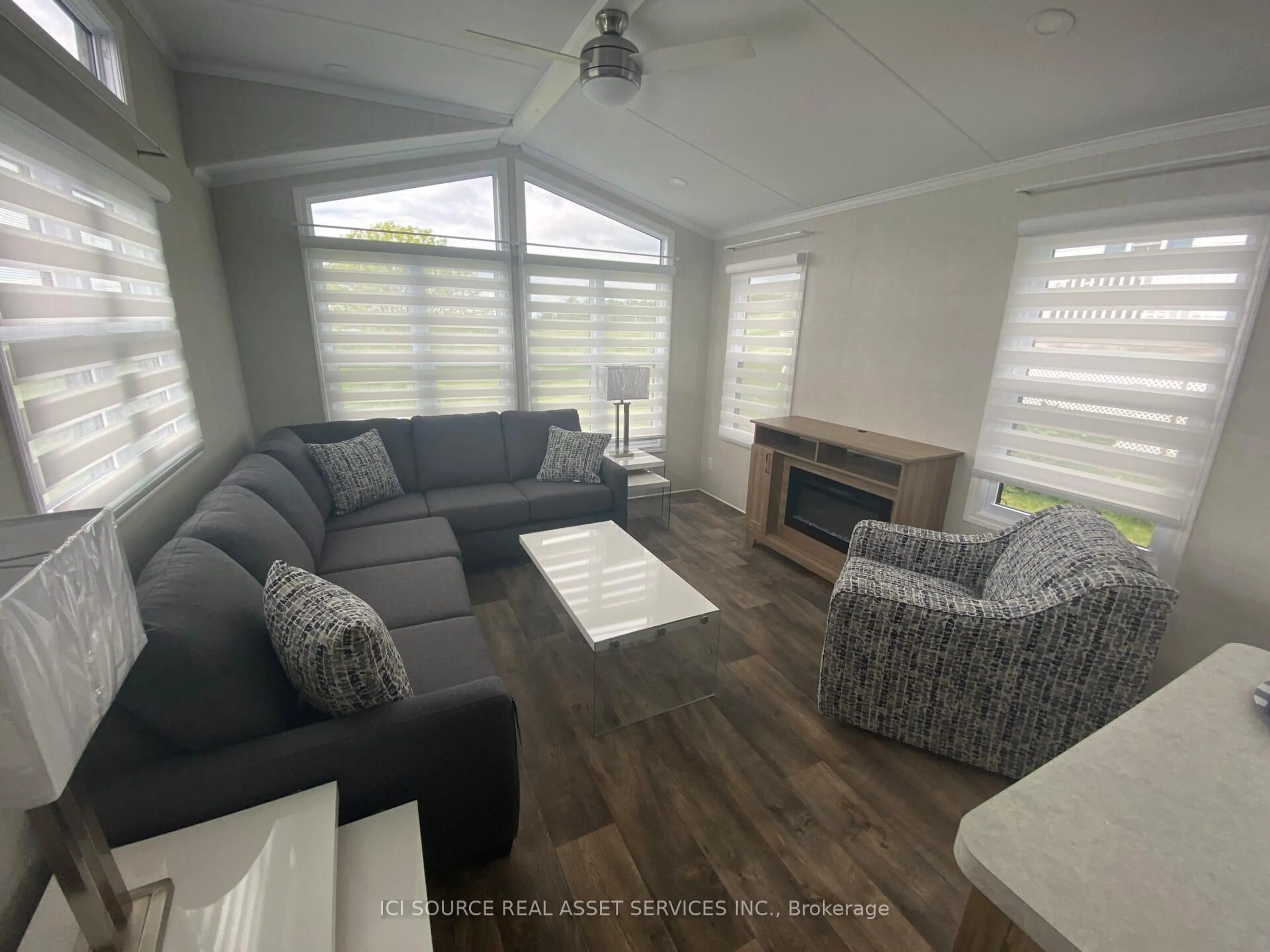 Living room with furniture, wood/laminate floor for 486 County Road 18 #TRILM, Prince Edward County Ontario K0K 1P0