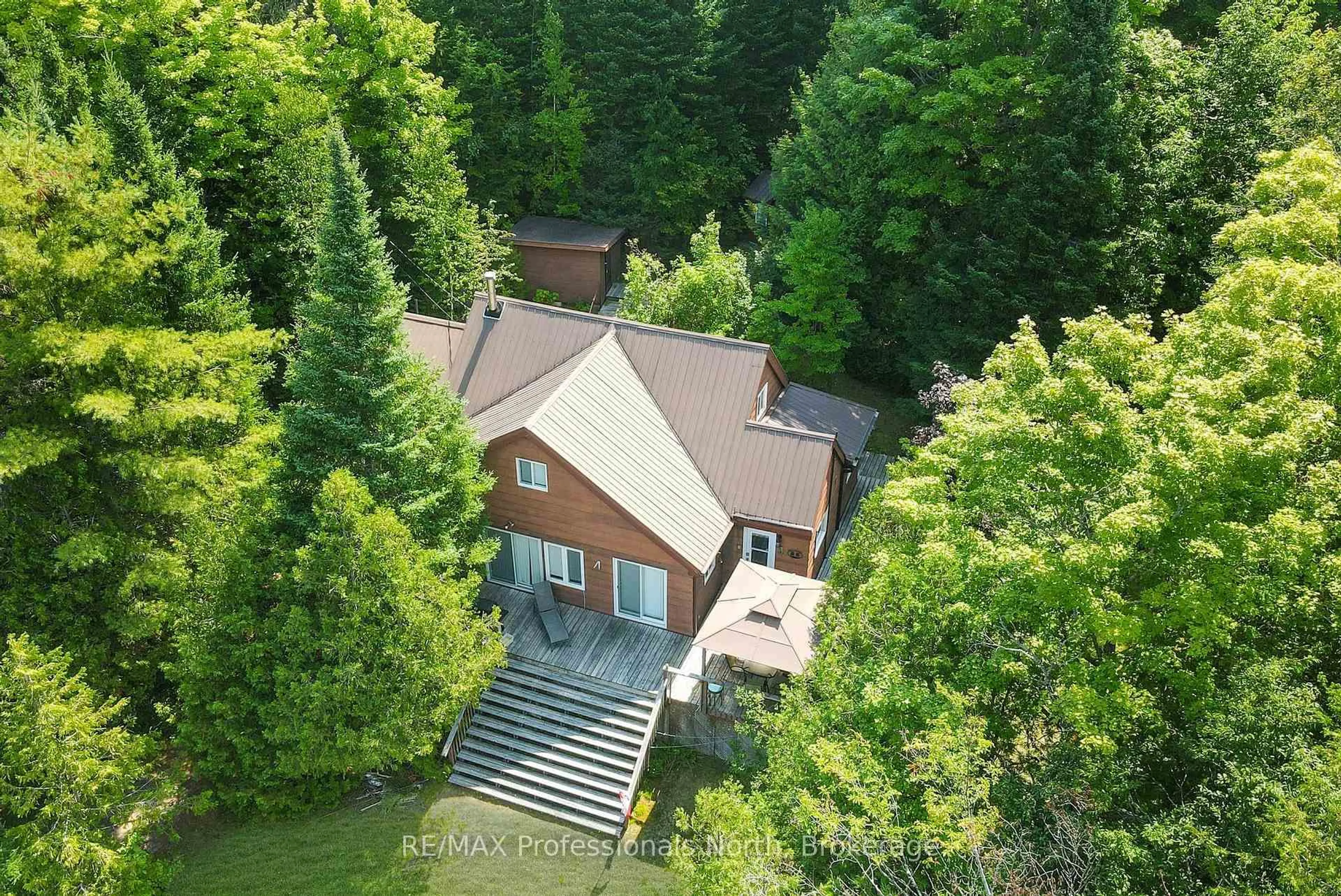 A pic from outside/outdoor area/front of a property/back of a property/a pic from drone, forest/trees view for 1026 Woodpecker Tr, Minden Hills Ontario K0M 2K0