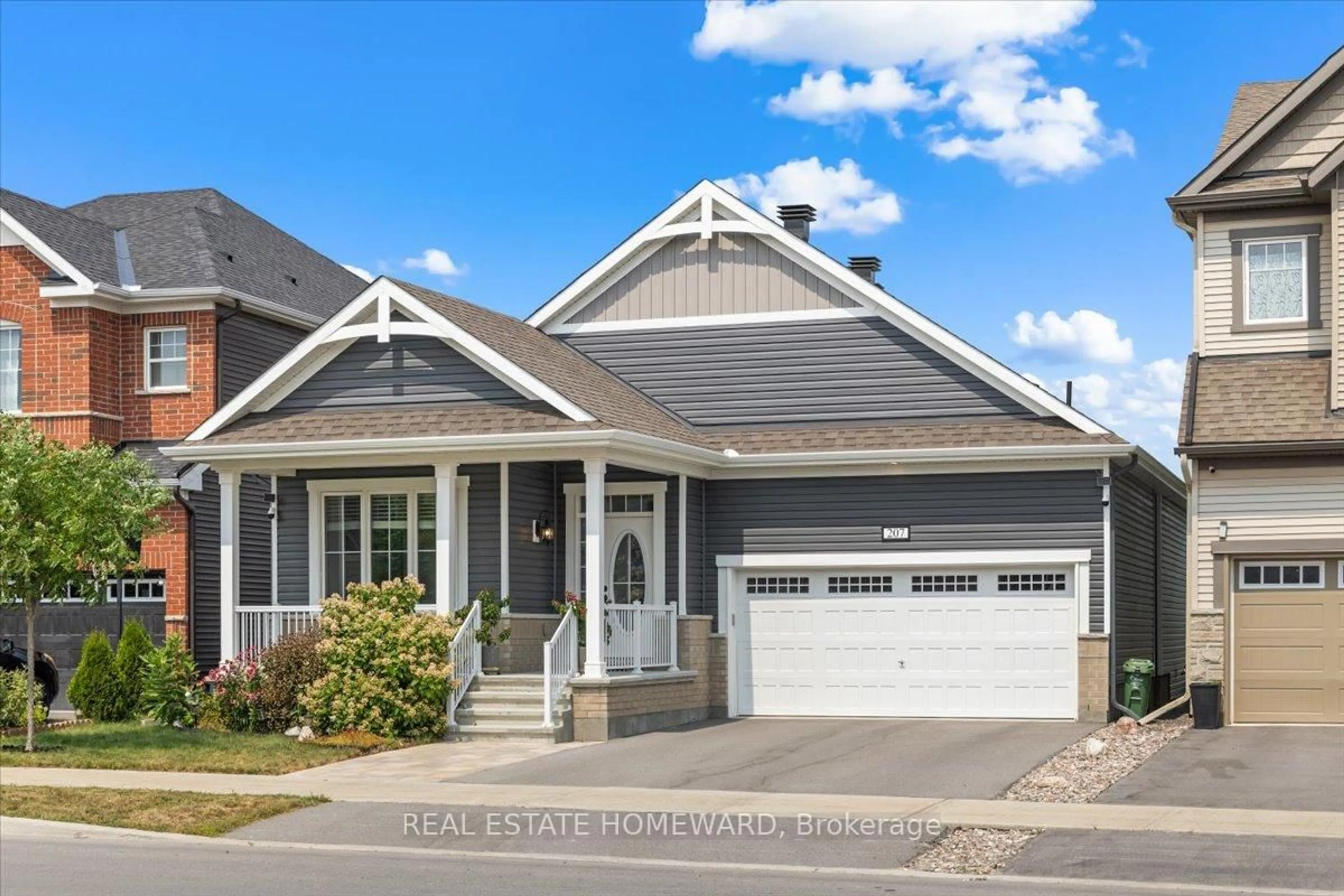 Home with vinyl exterior material, street for 207 Cranesbill Rd, Ottawa Ontario K2V 0N5