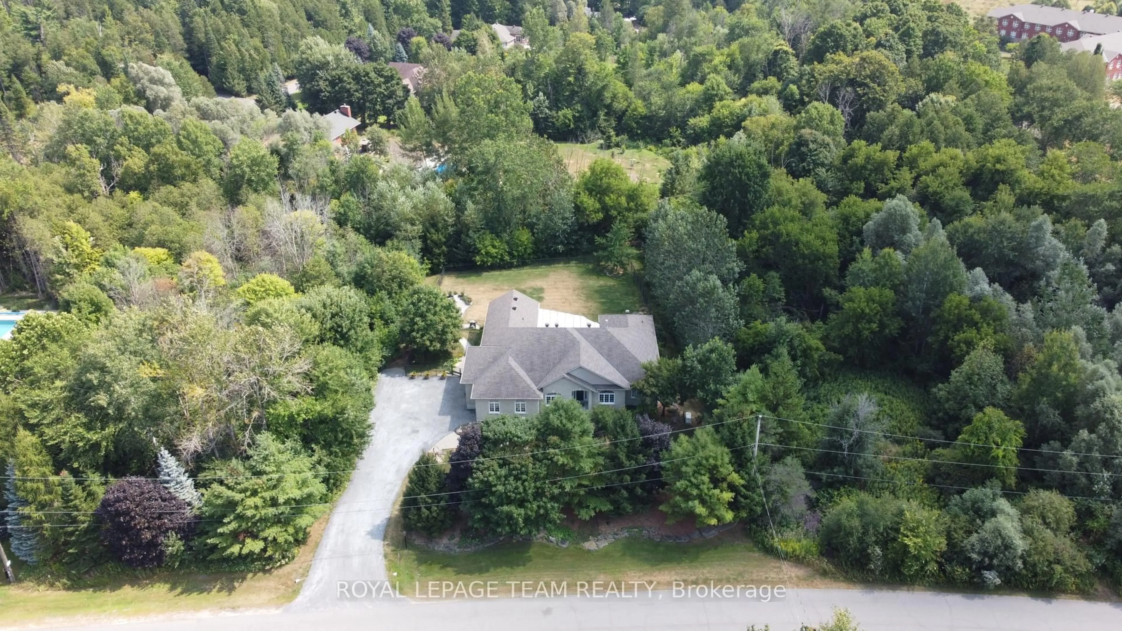 A pic from outside/outdoor area/front of a property/back of a property/a pic from drone, forest/trees view for 6196 Elkwood Dr, Ottawa Ontario K4P 1M9