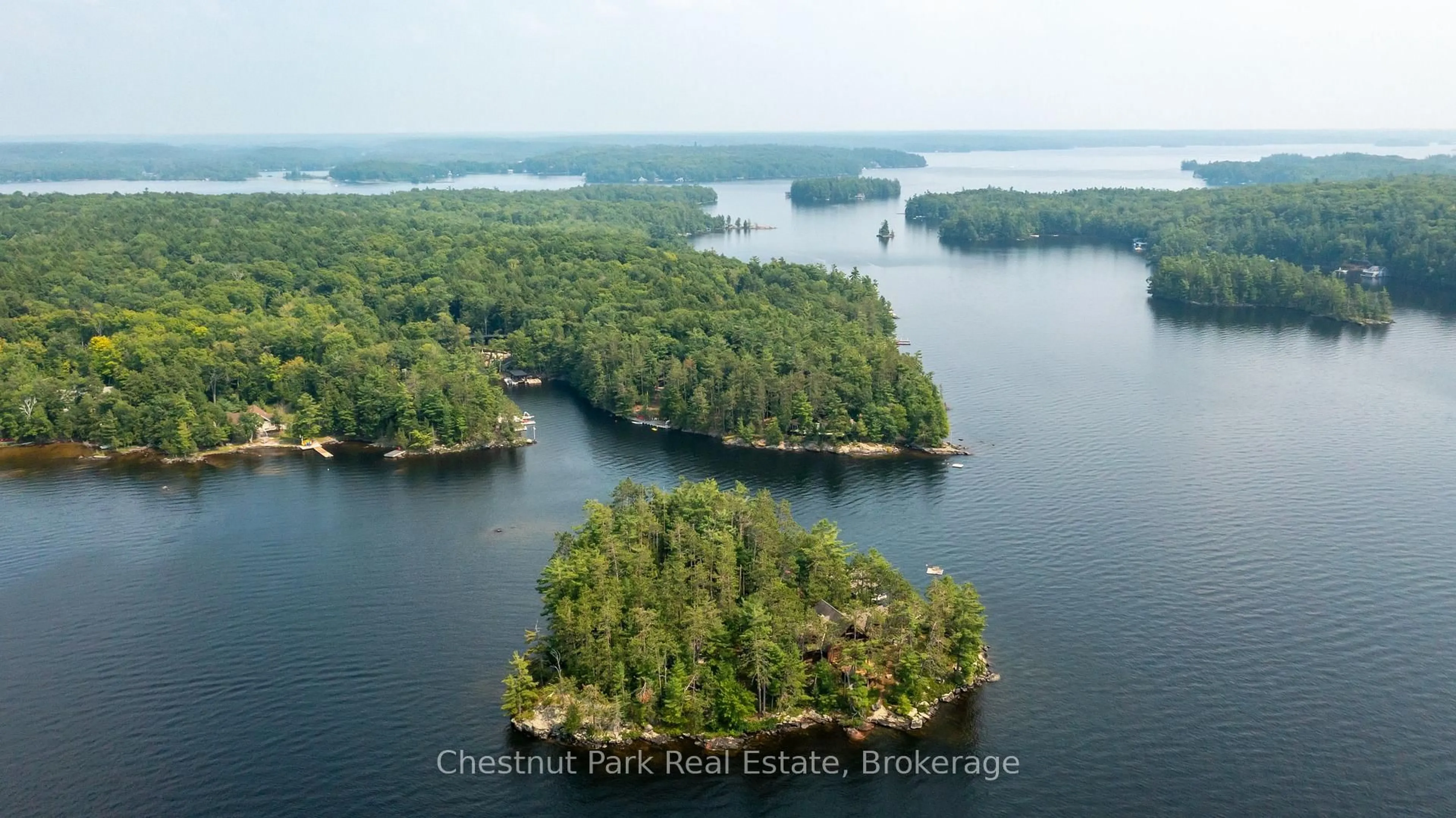 A pic from outside/outdoor area/front of a property/back of a property/a pic from drone, water/lake/river/ocean view for 1000 Little Baxter (AKA Rockwood) Island, Bracebridge Ontario P1L 1W8