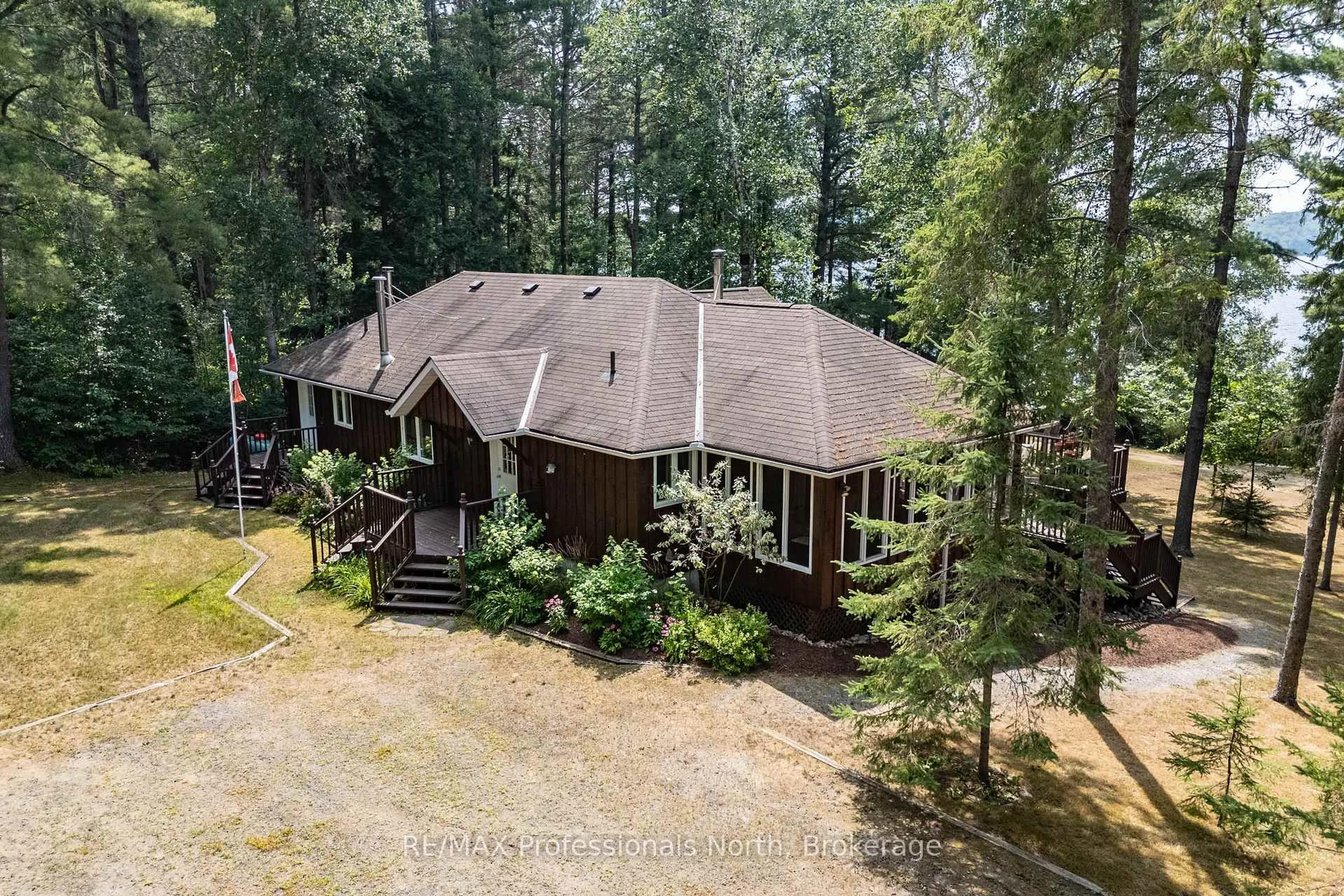 A pic from outside/outdoor area/front of a property/back of a property/a pic from drone, forest/trees view for 1140 Seabreeze Rd, Lake of Bays Ontario P0A 1H0